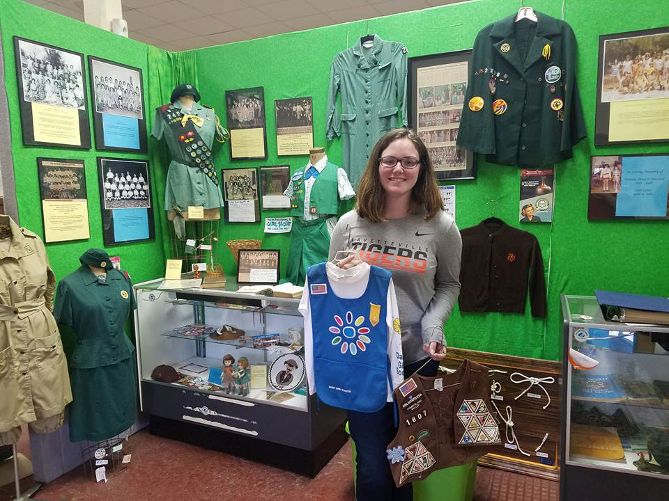 Pictured in 2017 donating my Daisy smock (2005) and Brownie vest (2007)