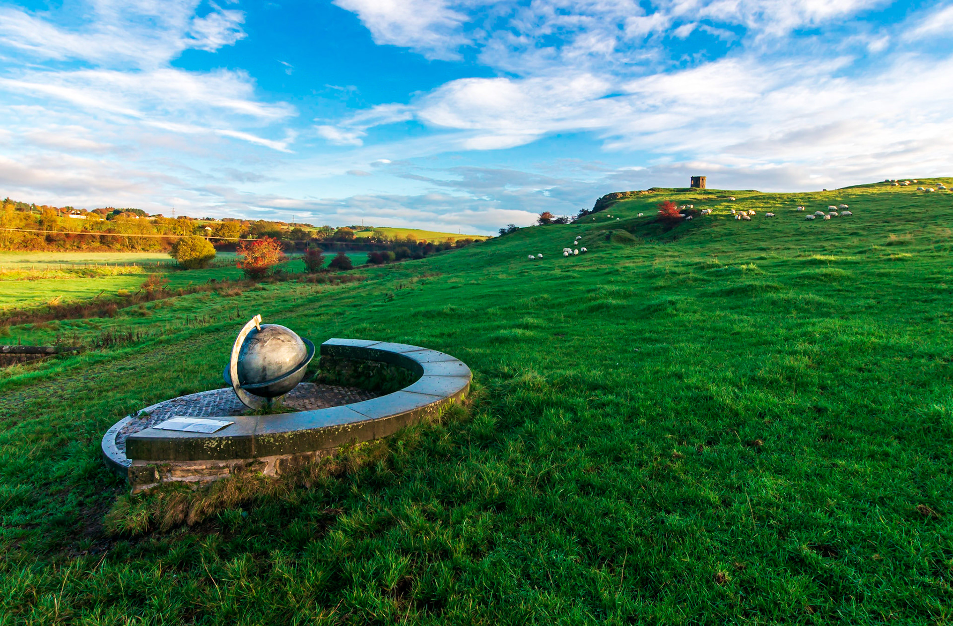 On the southern approach path to Kenmure hill is a bench to rest at with a globe at its centre.