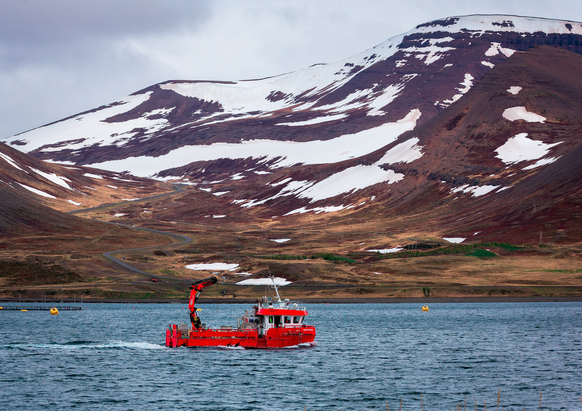 The fishing boat Hafnarnes returns to its home port of Thingeyri in the Icelandic Westfjords region. This fishing boat may be named after a abandoned fishing hamlet of Hafnarnes in East Iceland.