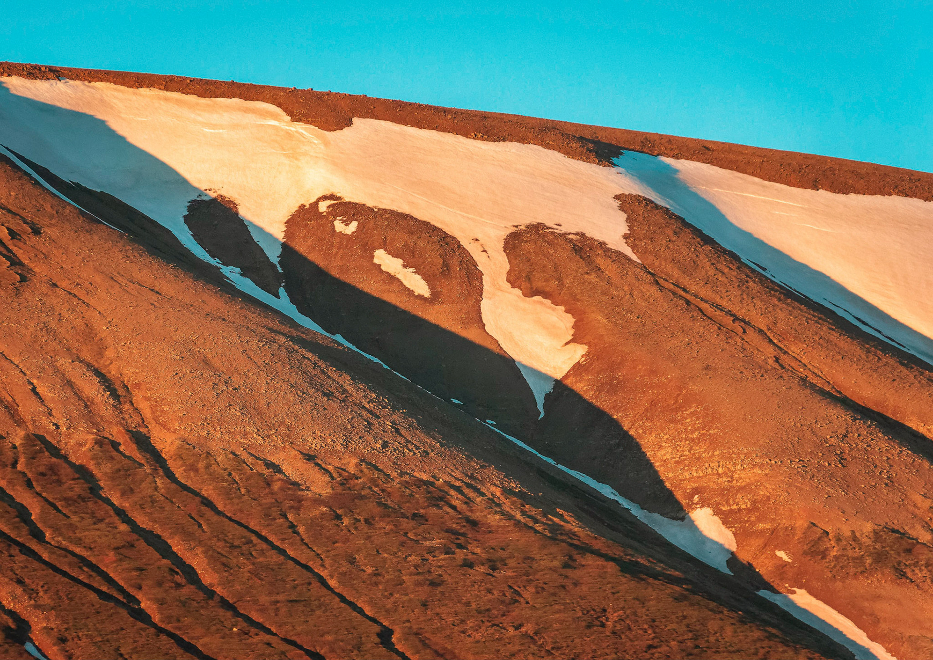 Last patchy snow on Birningsstaðafjall mountain in Icelands Northeastern Region.