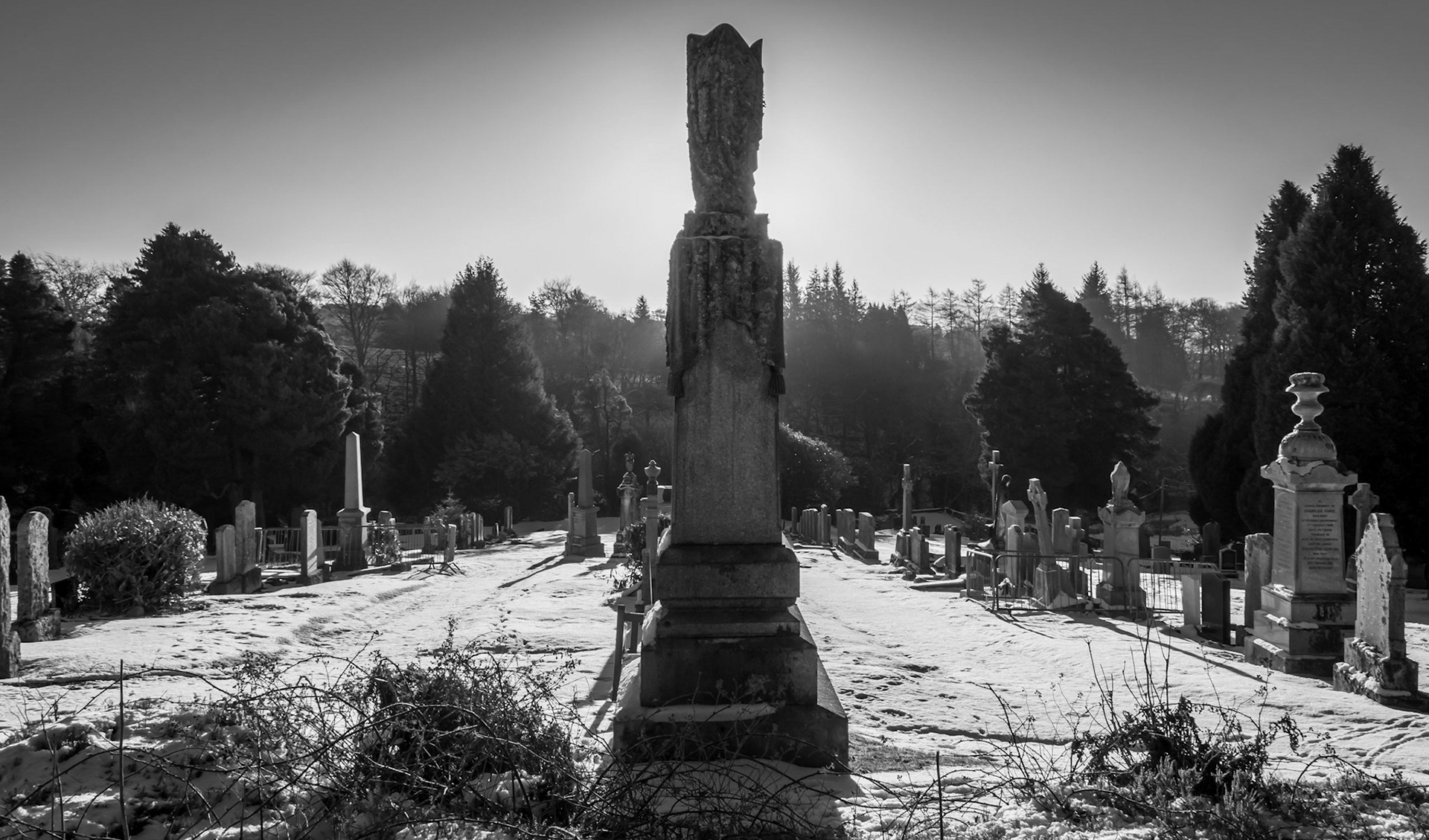 Sunrises behind a large gravestone.