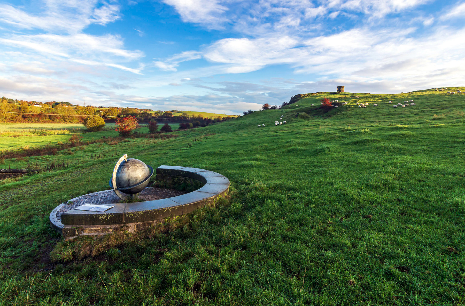 On the southern approach path to Kenmure hill is a bench to rest at with a globe at its centre.
