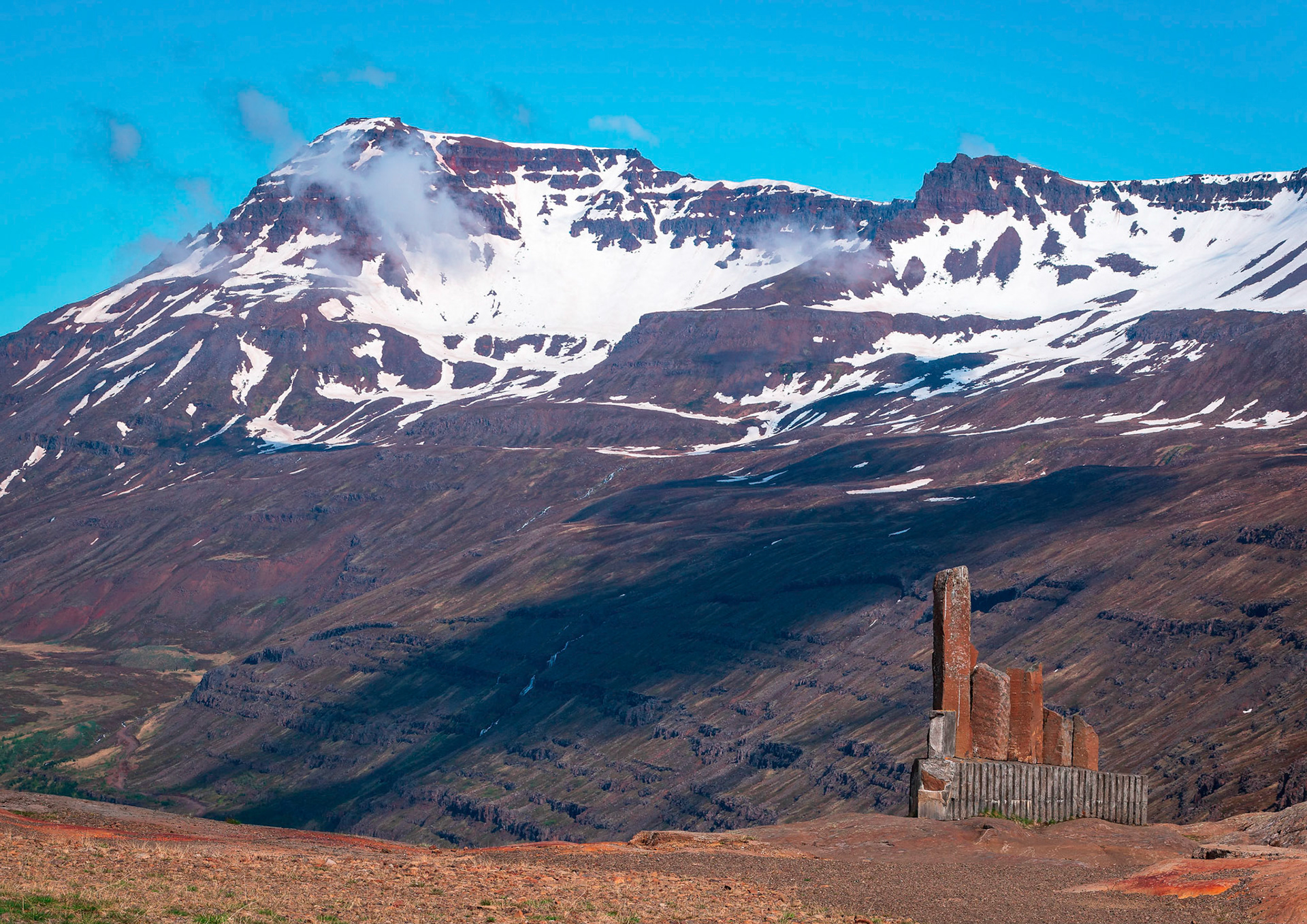 This memorial was erected to remember Þorbjörn Arnoddsson by the people of Seyðisfjörður. Þorbjörn Arnoddsson was a pioneer of winter travel over Fjarðarheiði mountain pass near the town of Seyðisfjörður.