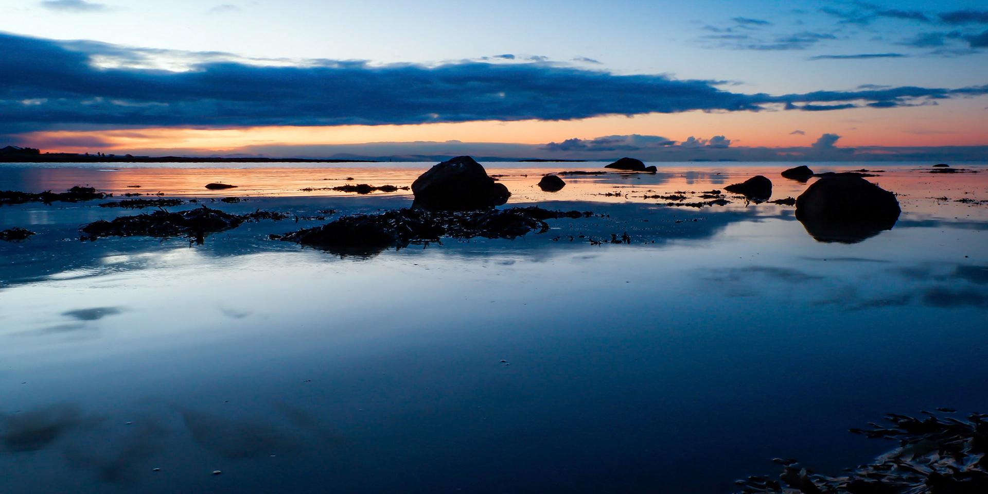 Ealy morning over a rock and pool  covered beach on the North Ayrshire coast.