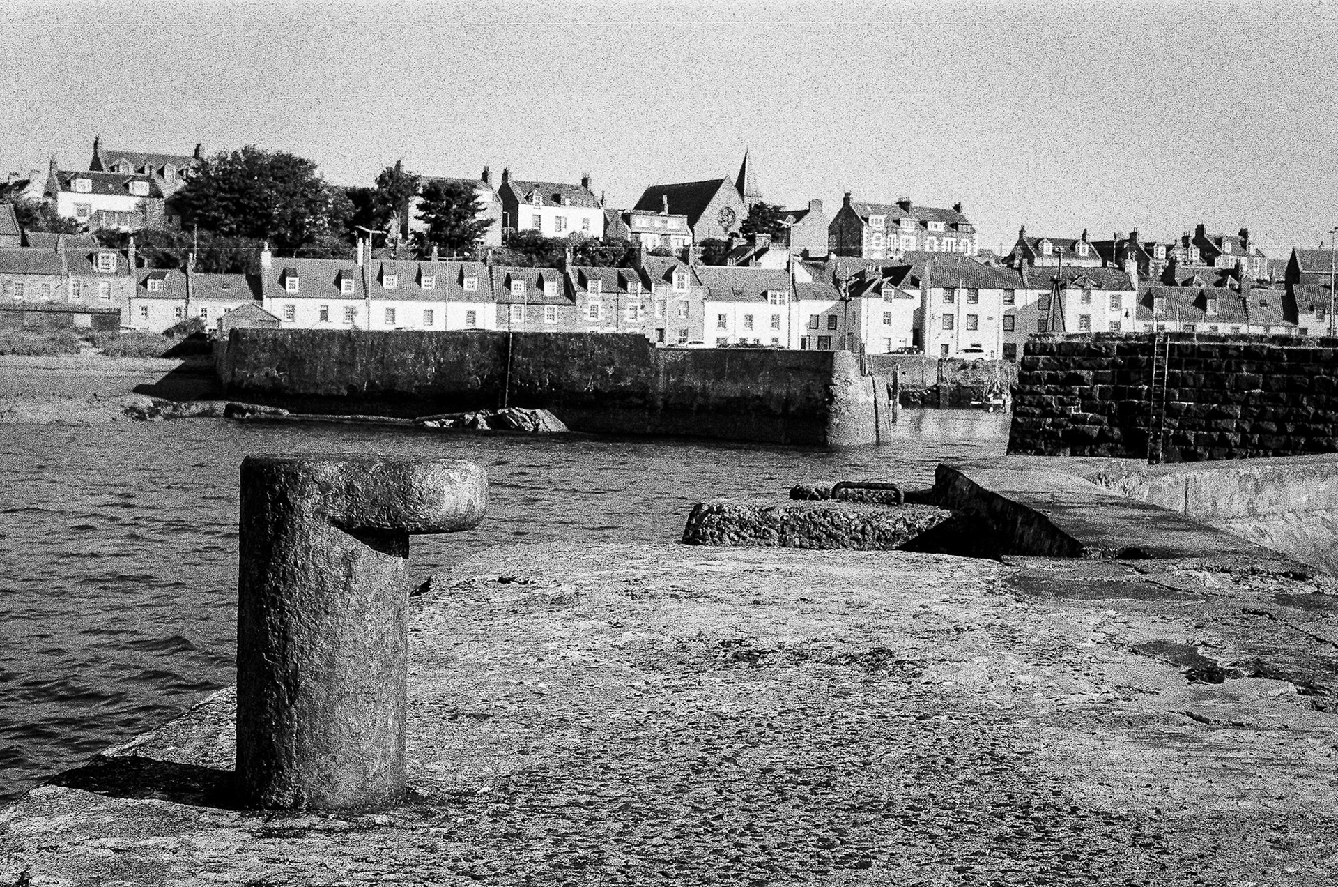 A weather worn bollard sits outside the entrance to St Monans harbour.