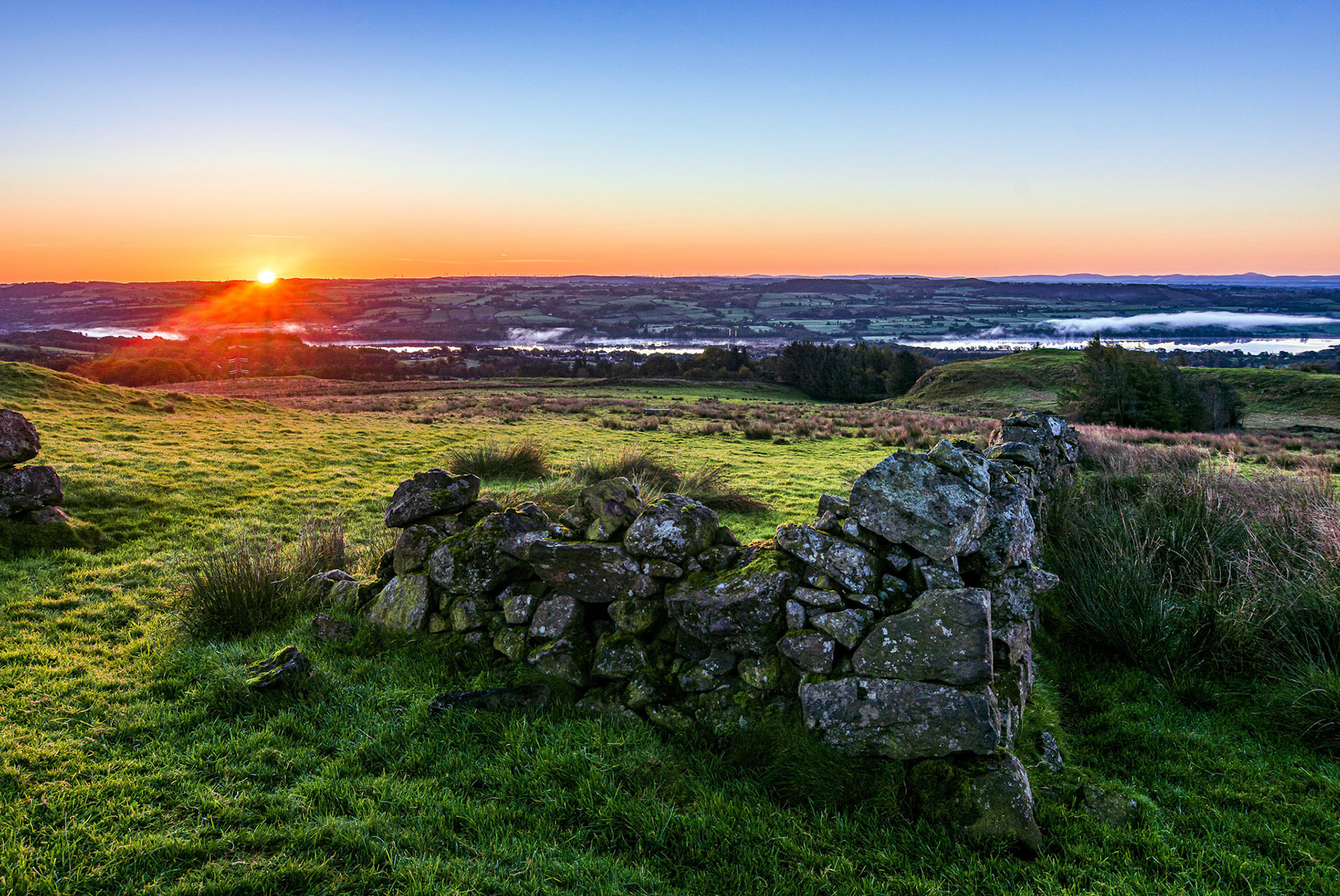 Sunrises over hills to the east of the Renfrewshire village of Lochwinnoch.