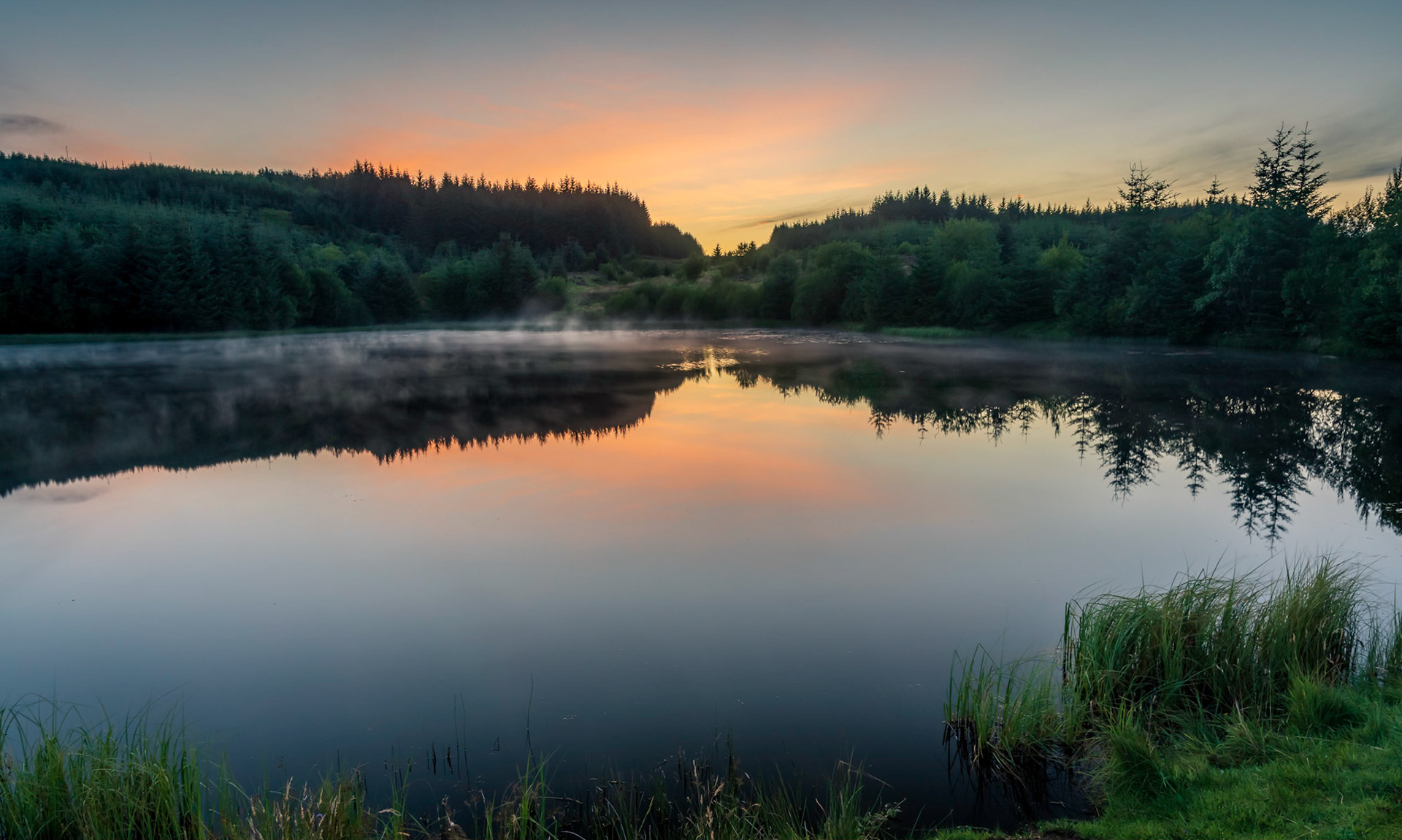 As night falls the last light of the day strikes Ladymuir Reservoir.