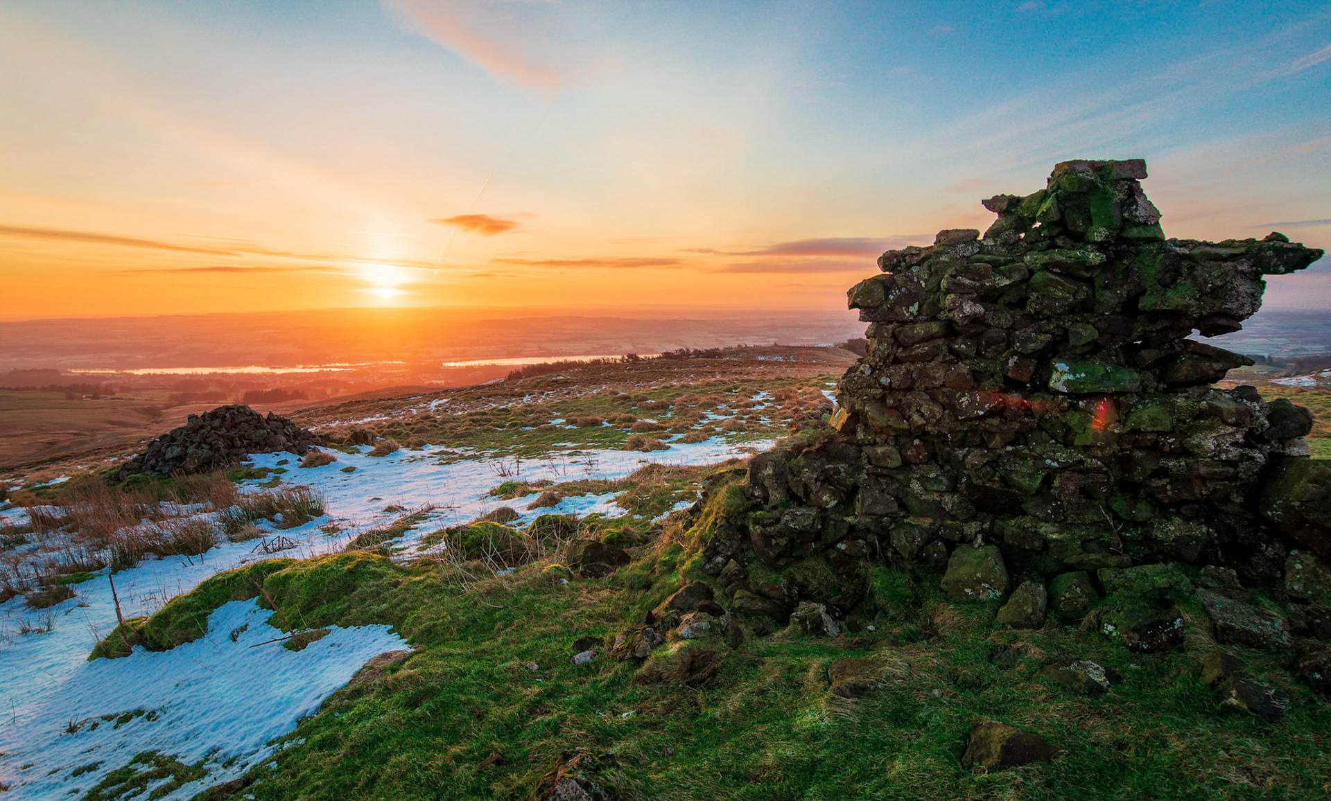 At sunrise the ruins of a shooting lodge sits on Lairdside Hill looking down on the Renfrewshire village of Lochwinnoch.