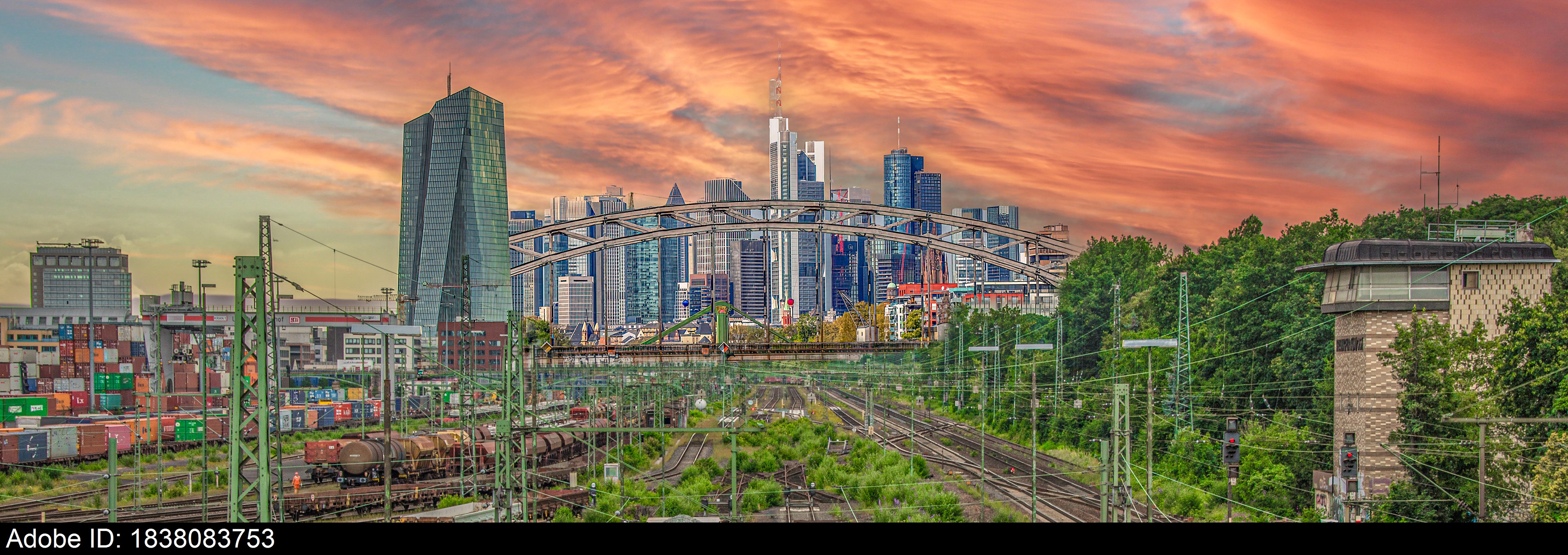 1838083753  Frankfurt City Skyline and Rail Yard at Sunset with Dramatic Orange Sky and Copy Space
