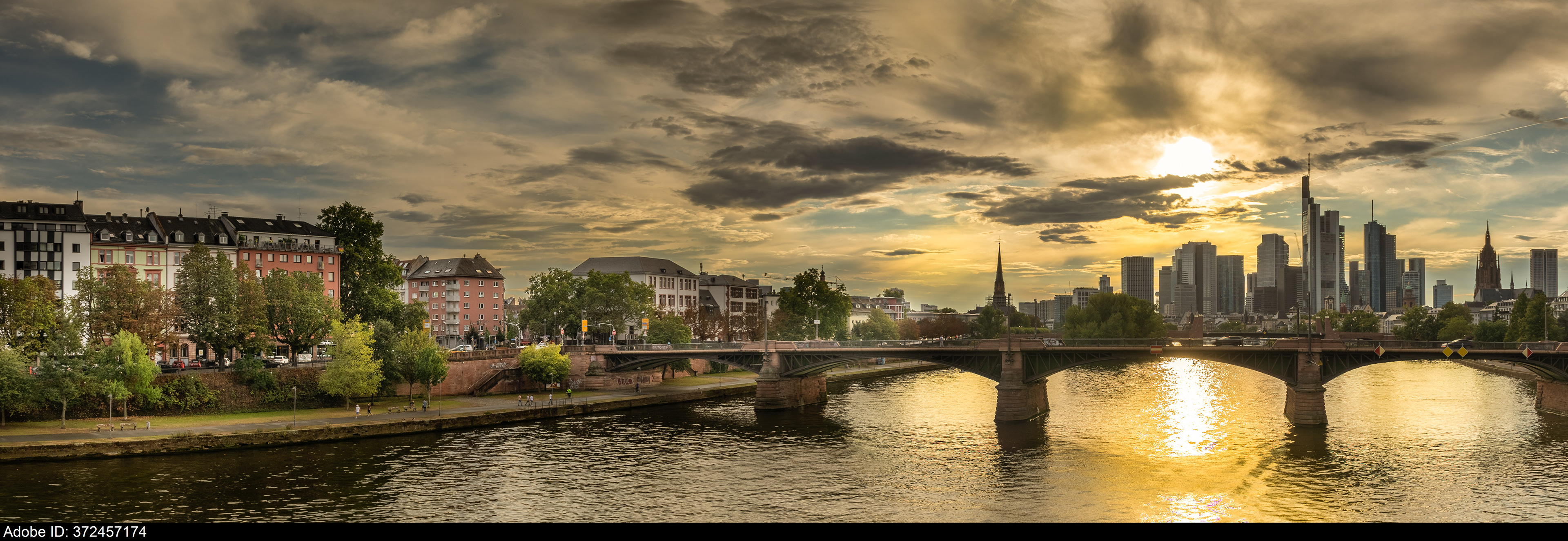 372457174  high resolution photo with the sun shining over buildings during frankfurt germany sunset