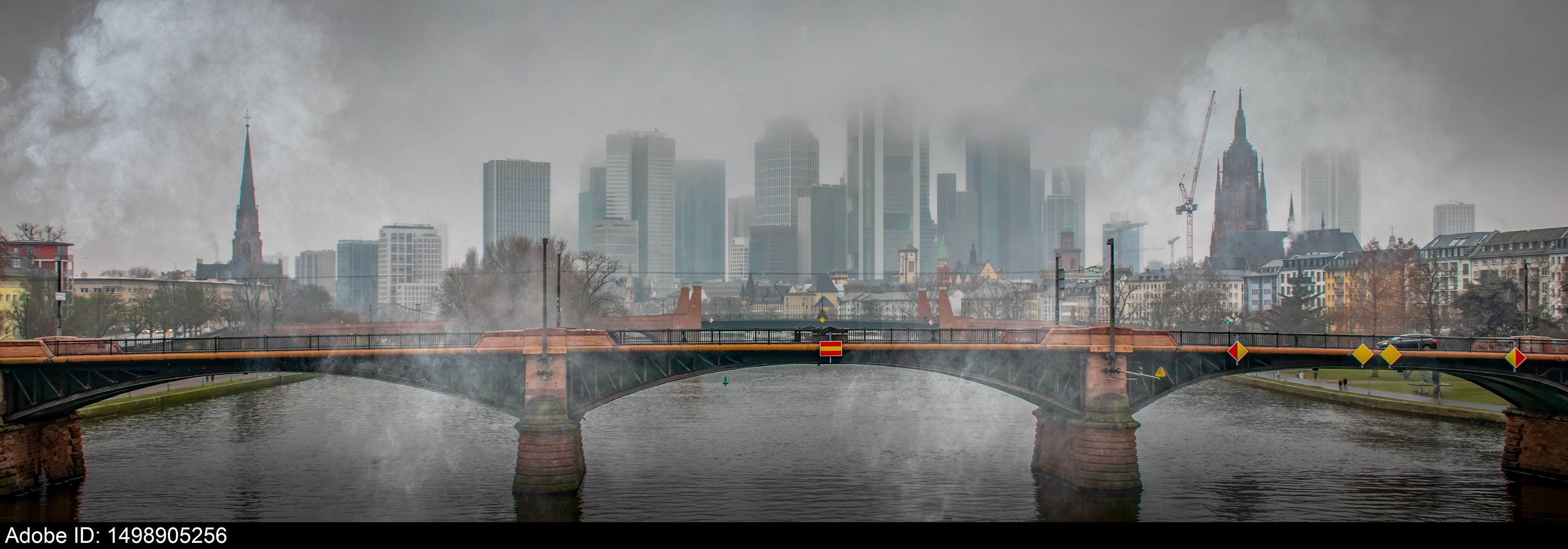 1498905256  Foggy Morning View of Ignatz-Bubis Bridge and Frankfurt Skyline