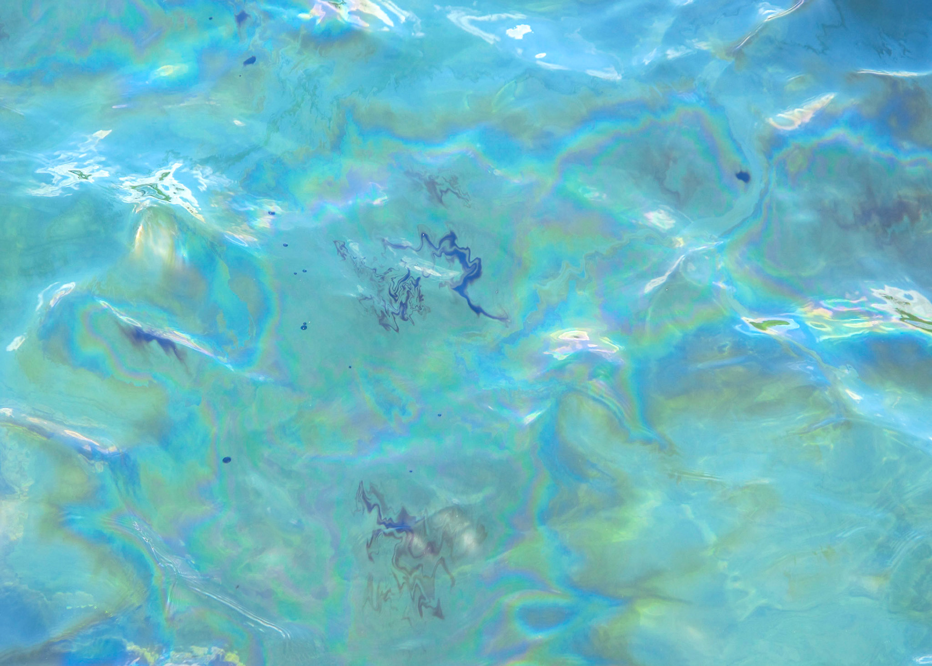 Oil on water, leaking from USS Arizona.  Pearl Harbor, Hawaii.
