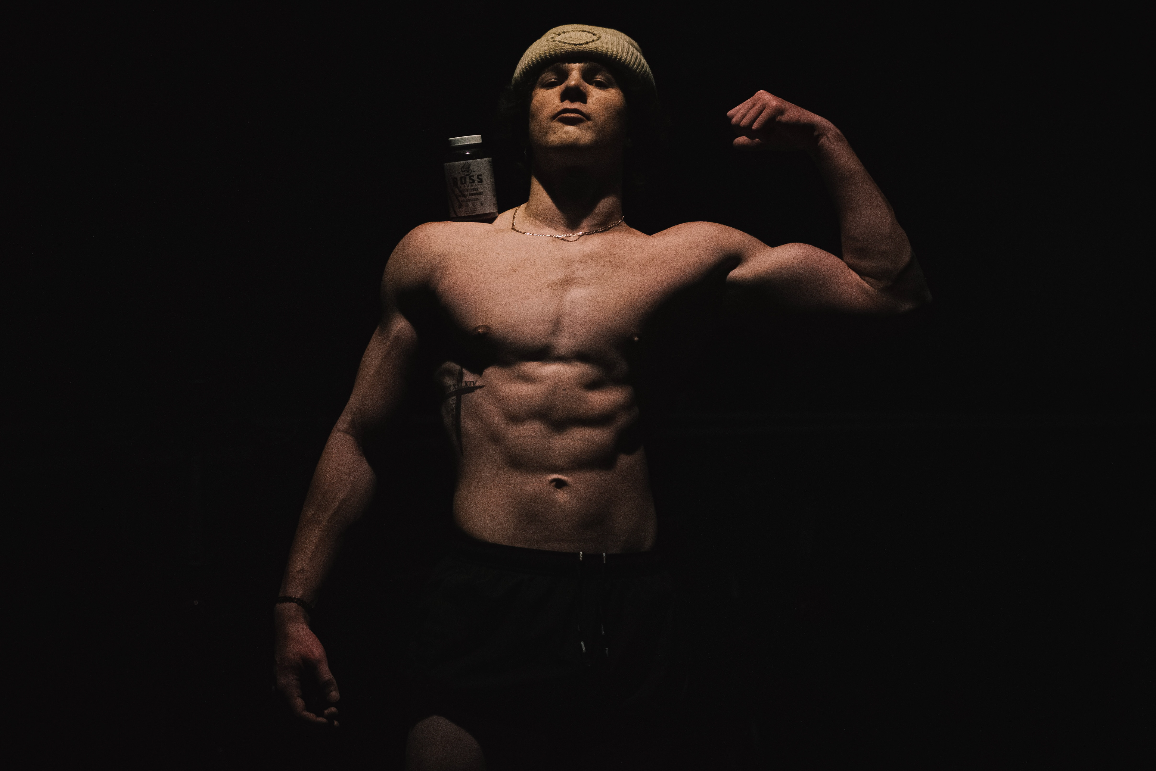 Posing with a vitamin supplement, Boss Bears, Peyton Green, flexes after a weightlifting workout. Green, a junior in high school, works out regularly at VASA fitness in Centennial, Colorado and he received sponsorships from companies on Instagram promoting weightlifting and a healthy lifestyle.