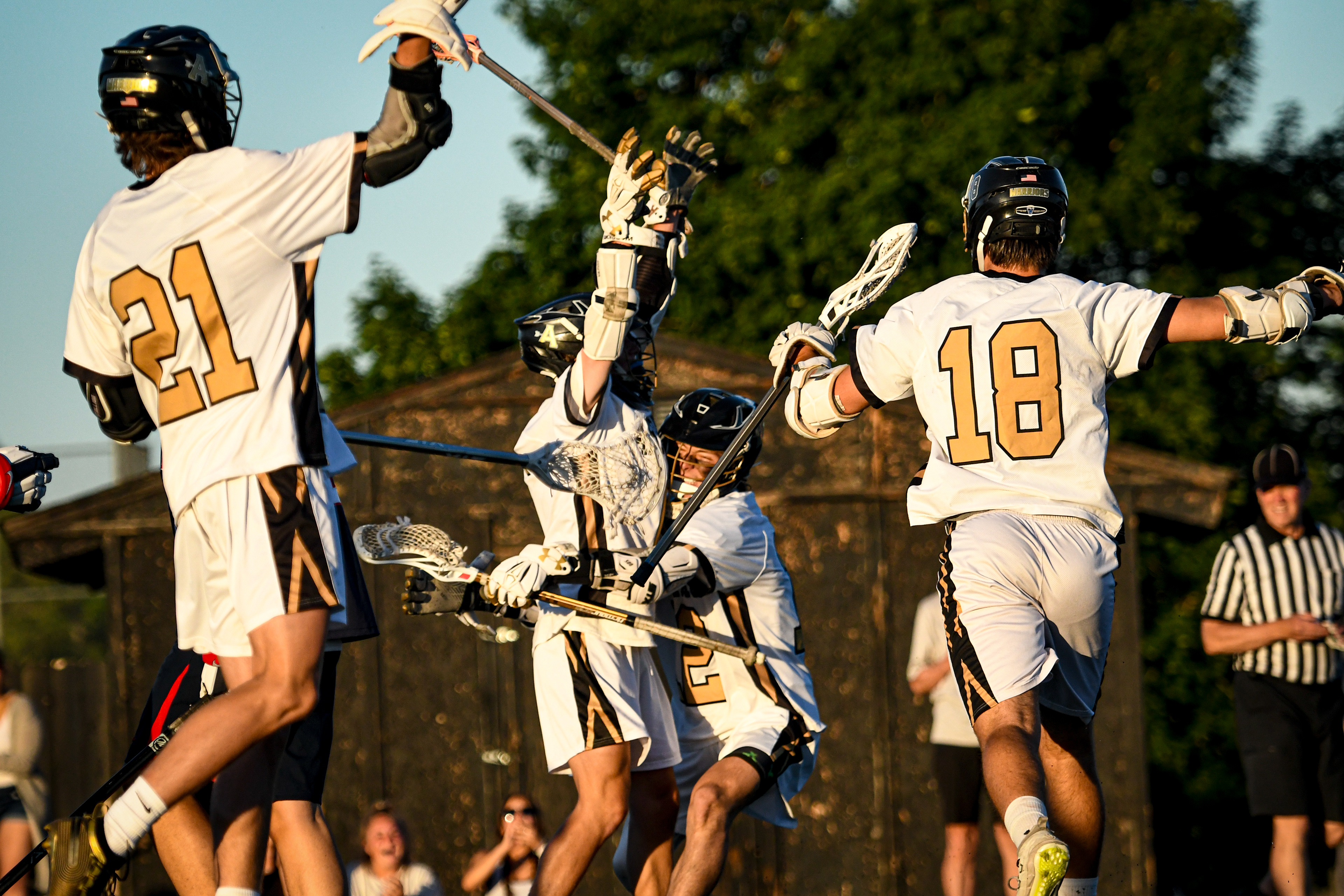Tommy Leonard celebrates a goal with his teammates during a varsity lacrosse game. Leonard (#12) helped lead his team to many victories as one of the starters for the Arapahoe Warriors and he consistently scored many points for his team.