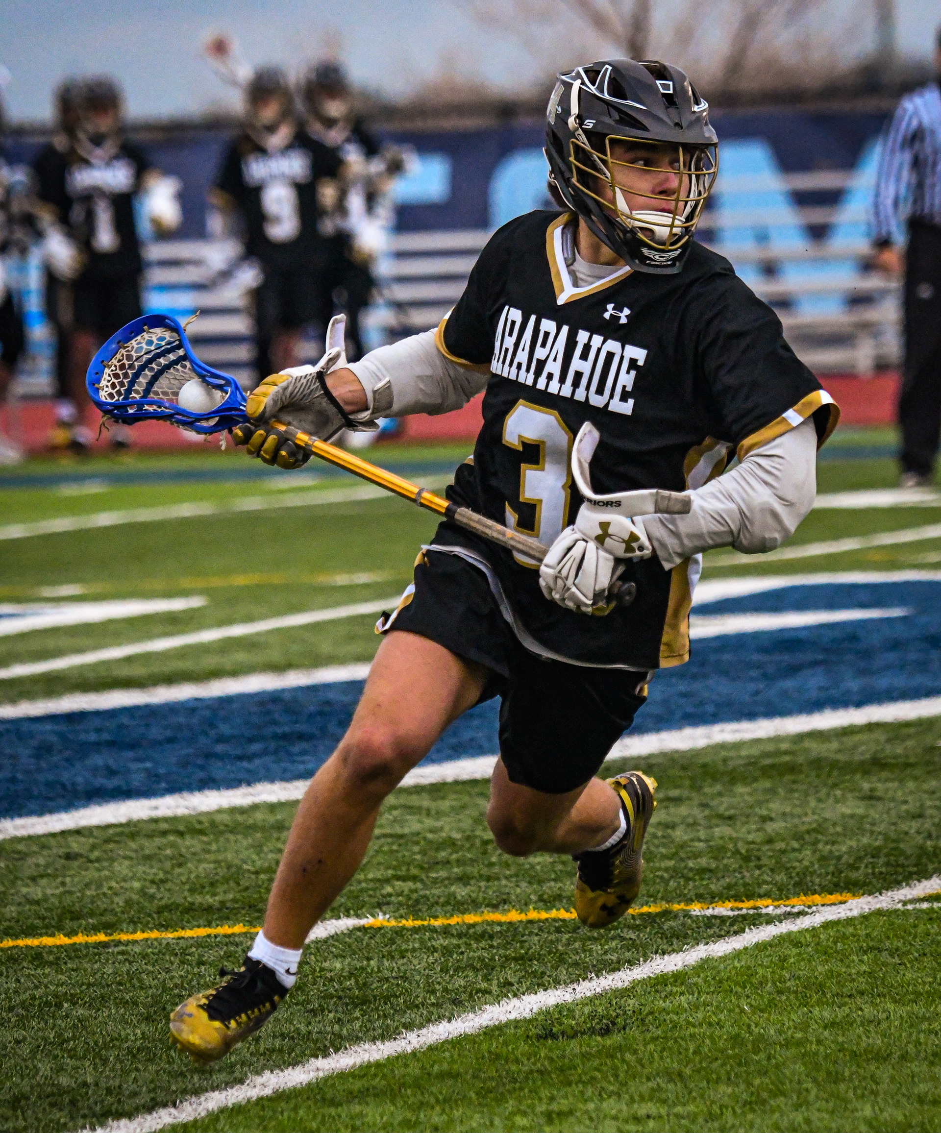  Running with the ball, lacrosse player Finn Hauhuth attempts a goal. Hauhuth, a varsity starter, helped the Arapahoe lacrosse team to many victories during the season and he committed to Yale University for lacrosse.