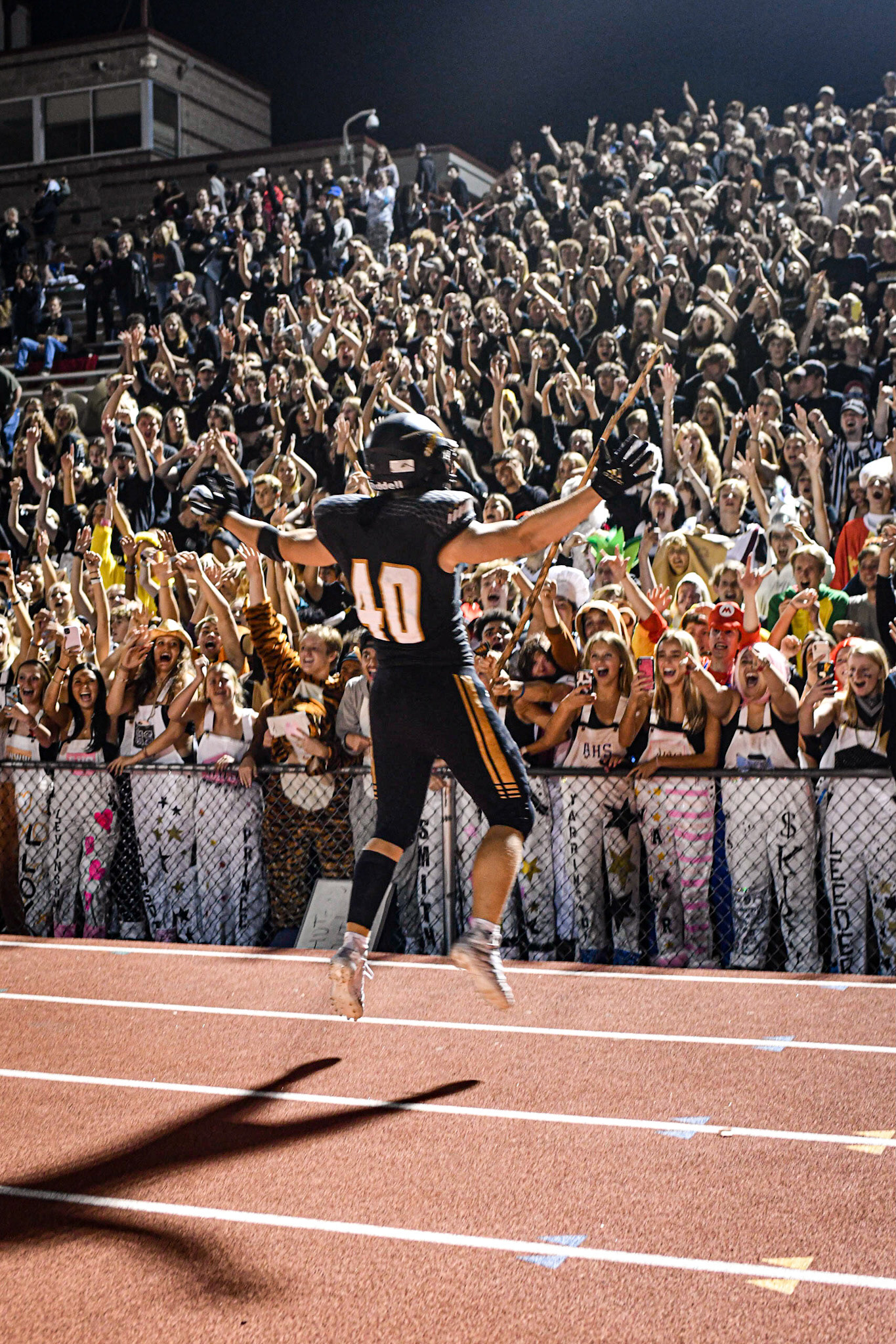 Sprinting to the ecstatic crowd after post game handshakes, Arapahoe senior Jack Weiler, celebrates a home victory over Heritage. The Warriors beat the cross town rival, the Eagles, 42-0 on September 3rd, 2021, in a packed house to retain the coveted Milk Jug Trophy.