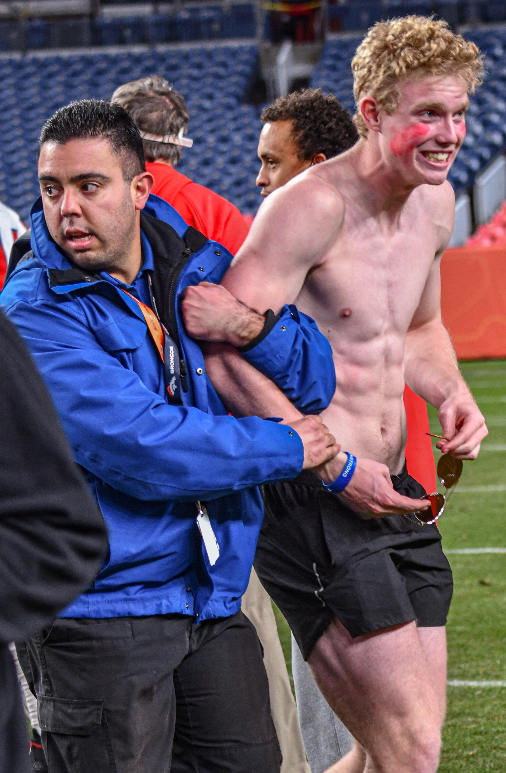  Held down by the arm by security, a Cherry Creek fan is apprehended and escorted off the field after jumping onto the turf at the end of the 5A State Football Championship Game. Cherry Creek defeated Valor Christain in a 21-0 shutout at Empower Field Stadium on December 4th, 2021.