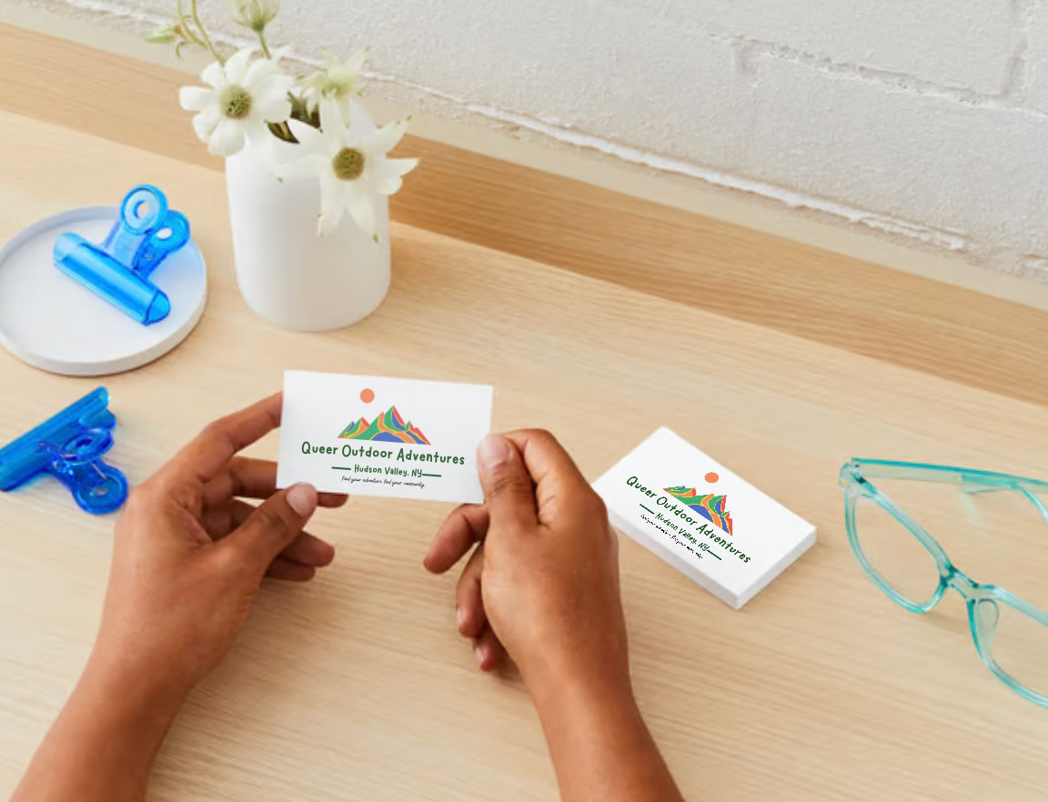 Hand holding QOA Business cards
