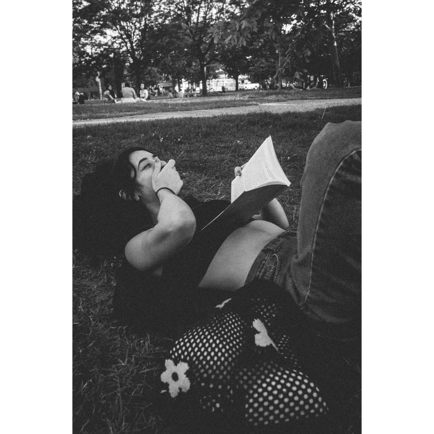 Rafaela reading in the park.