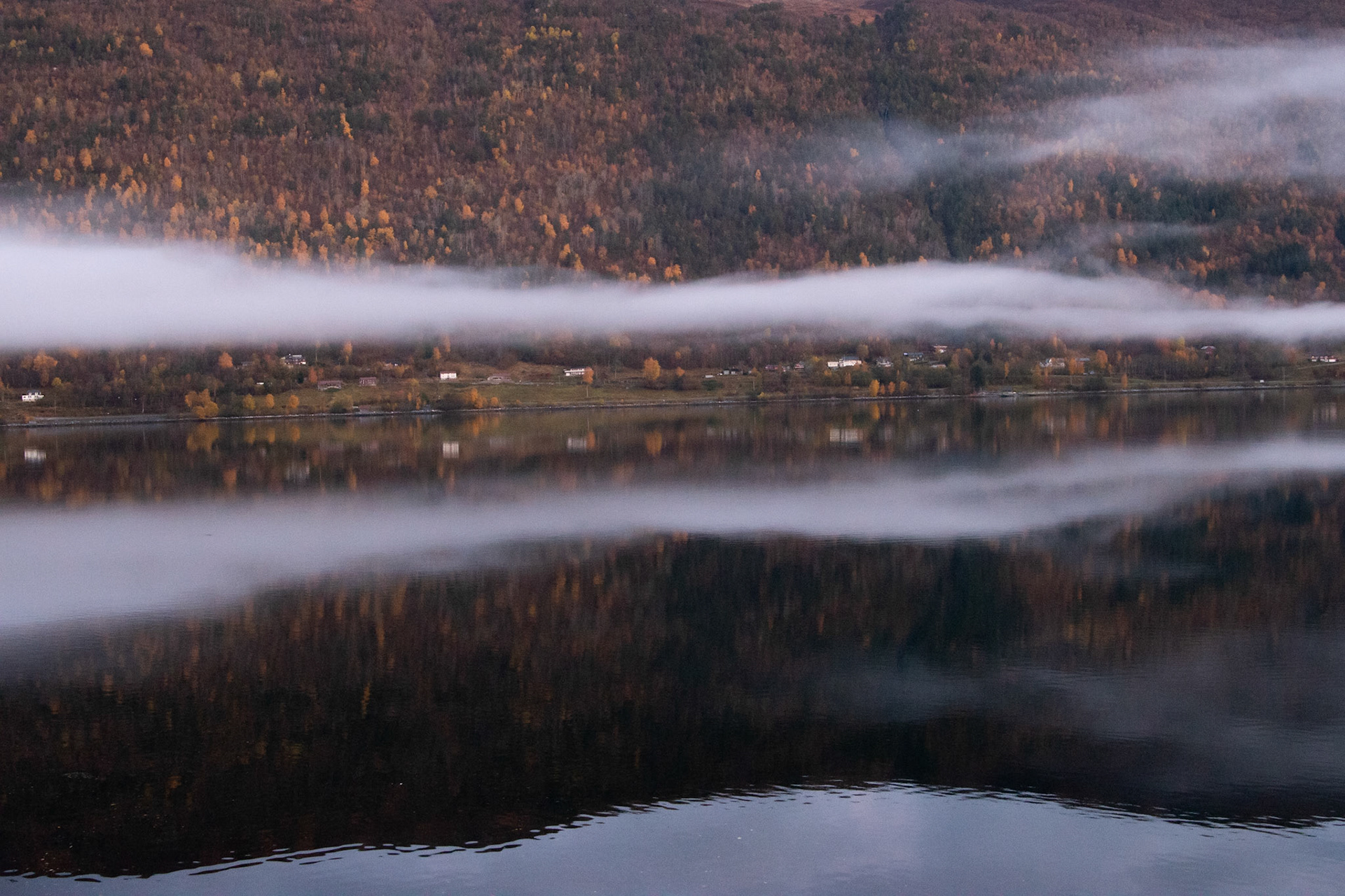 A serene tranquility of the Norwegian fjord. Sea, mountains and clouds. Peace.