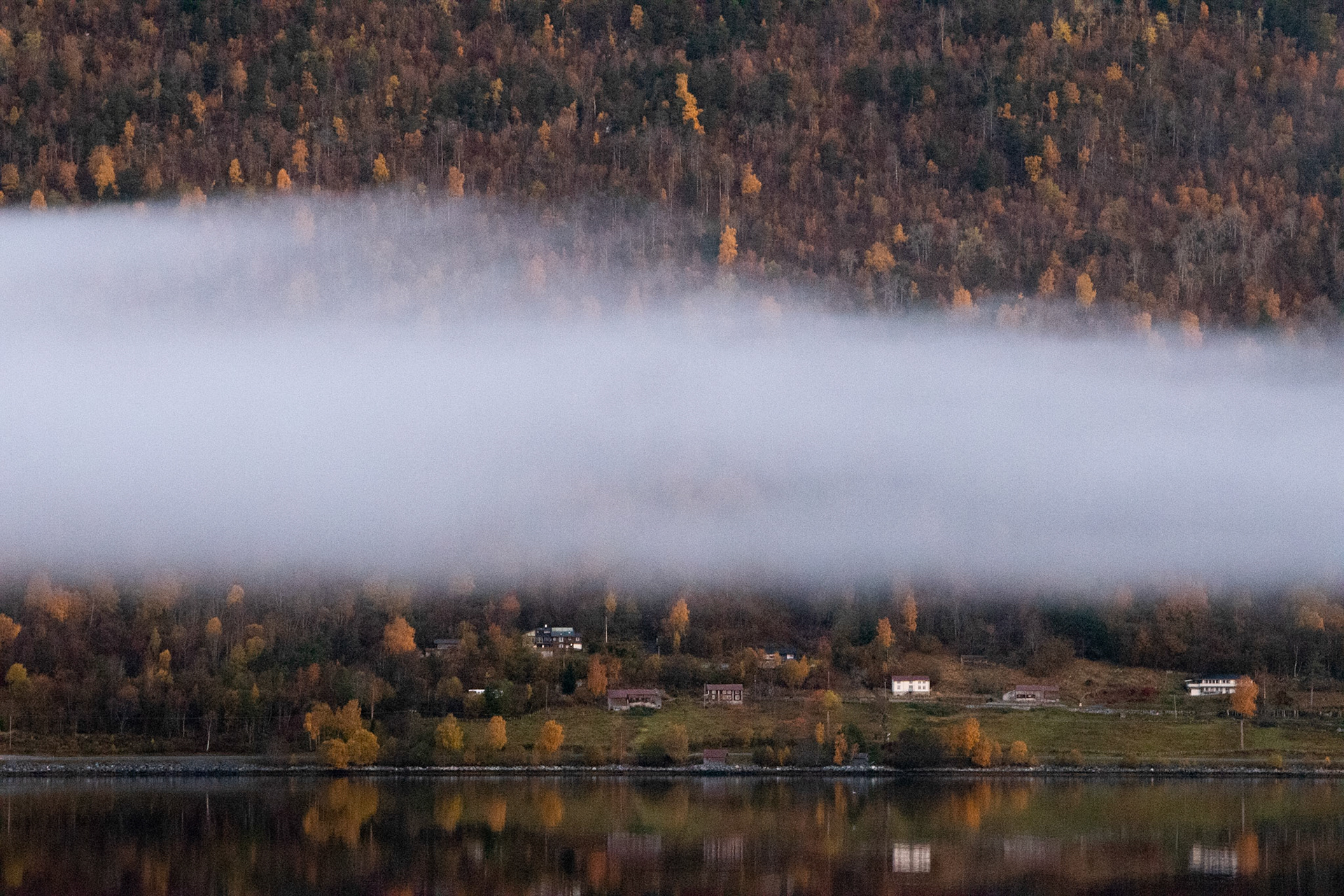 A serene tranquility of the Norwegian fjord. Sea, mountains and clouds. Peace. Awakenings.