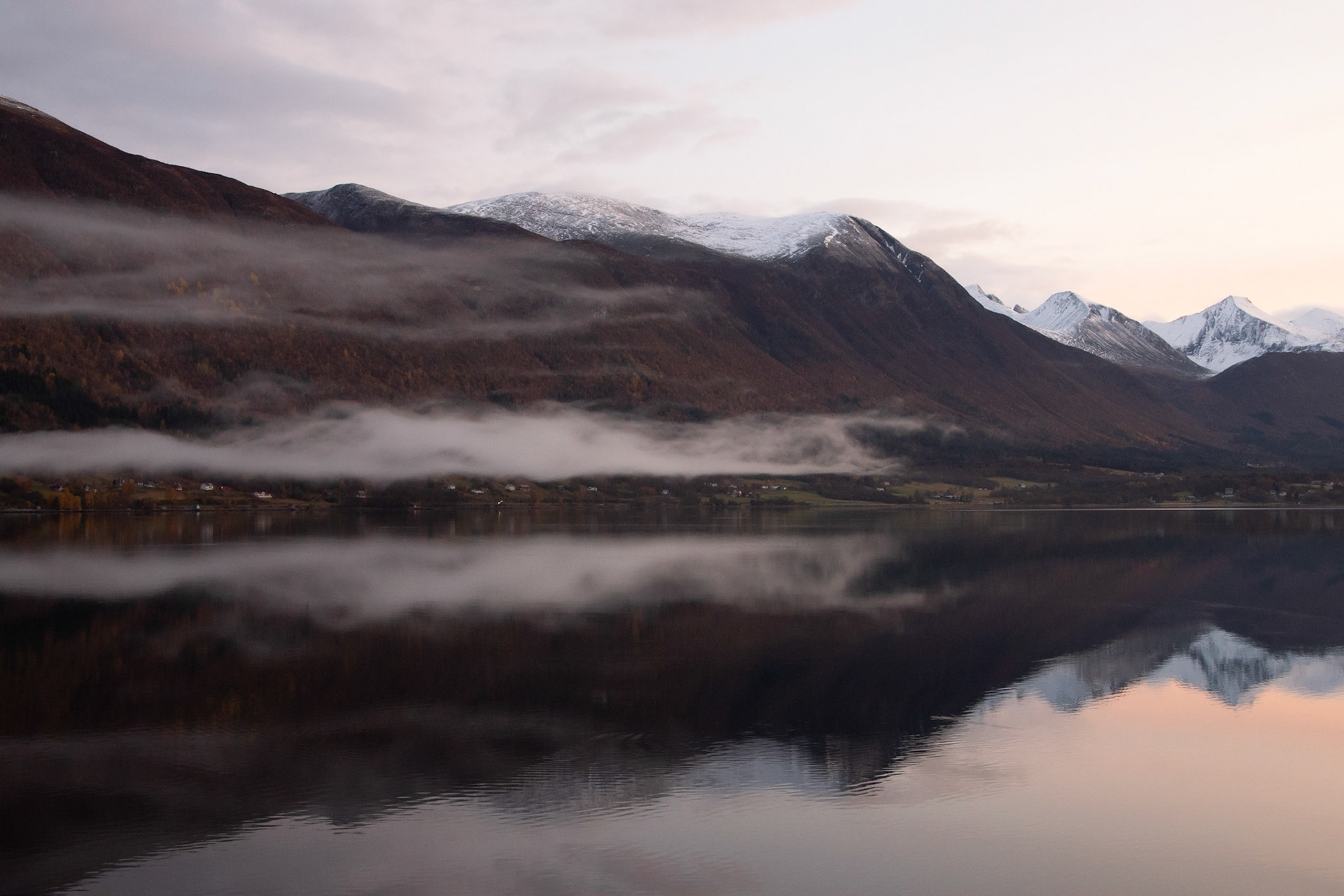 A serene tranquility of the Norwegian fjord. Sea, mountains and clouds.