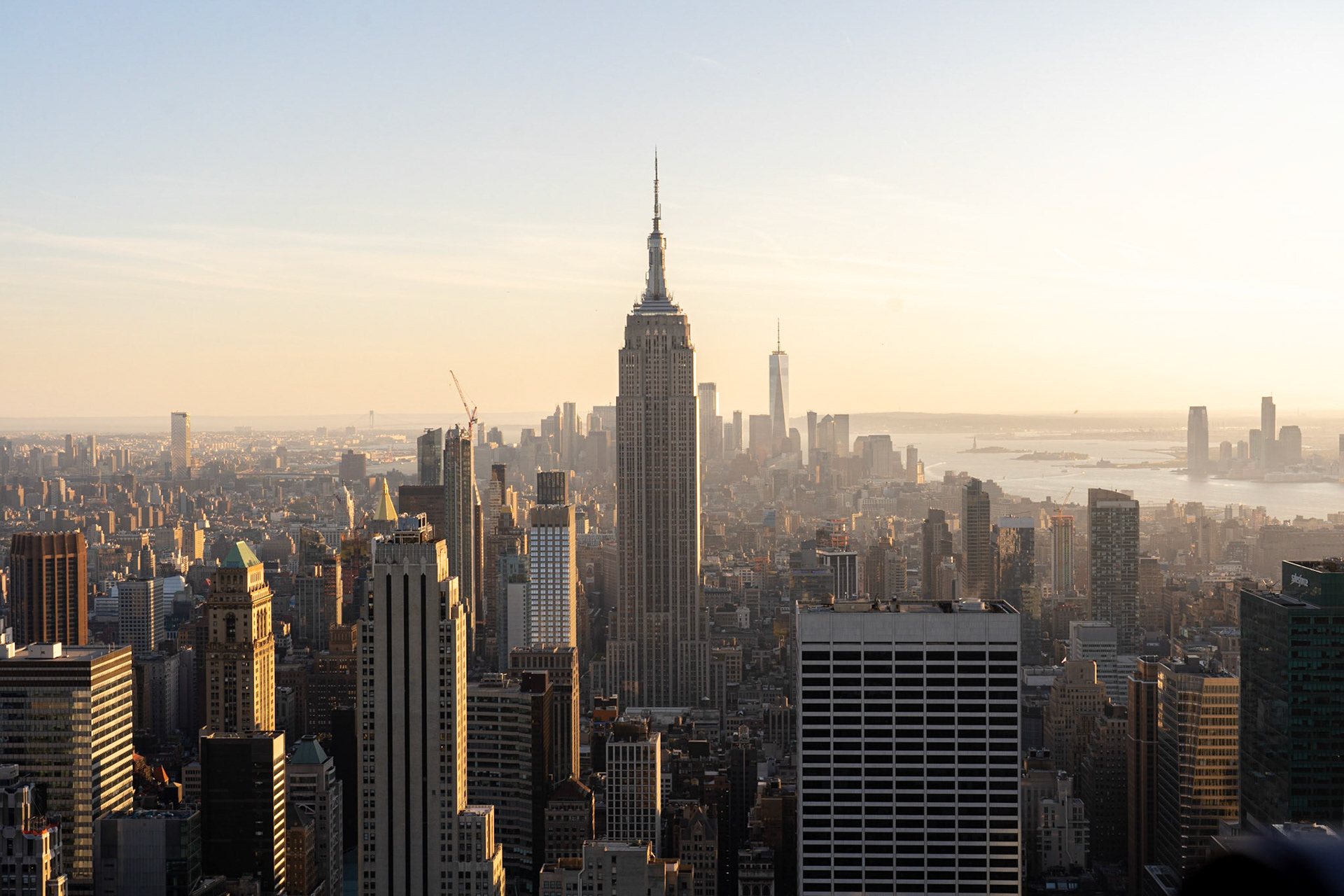 NYC, USA - September 21, 2019: NYC skyline, with the Empire State Building in the foreground seen from top of the Rockefeller Center
