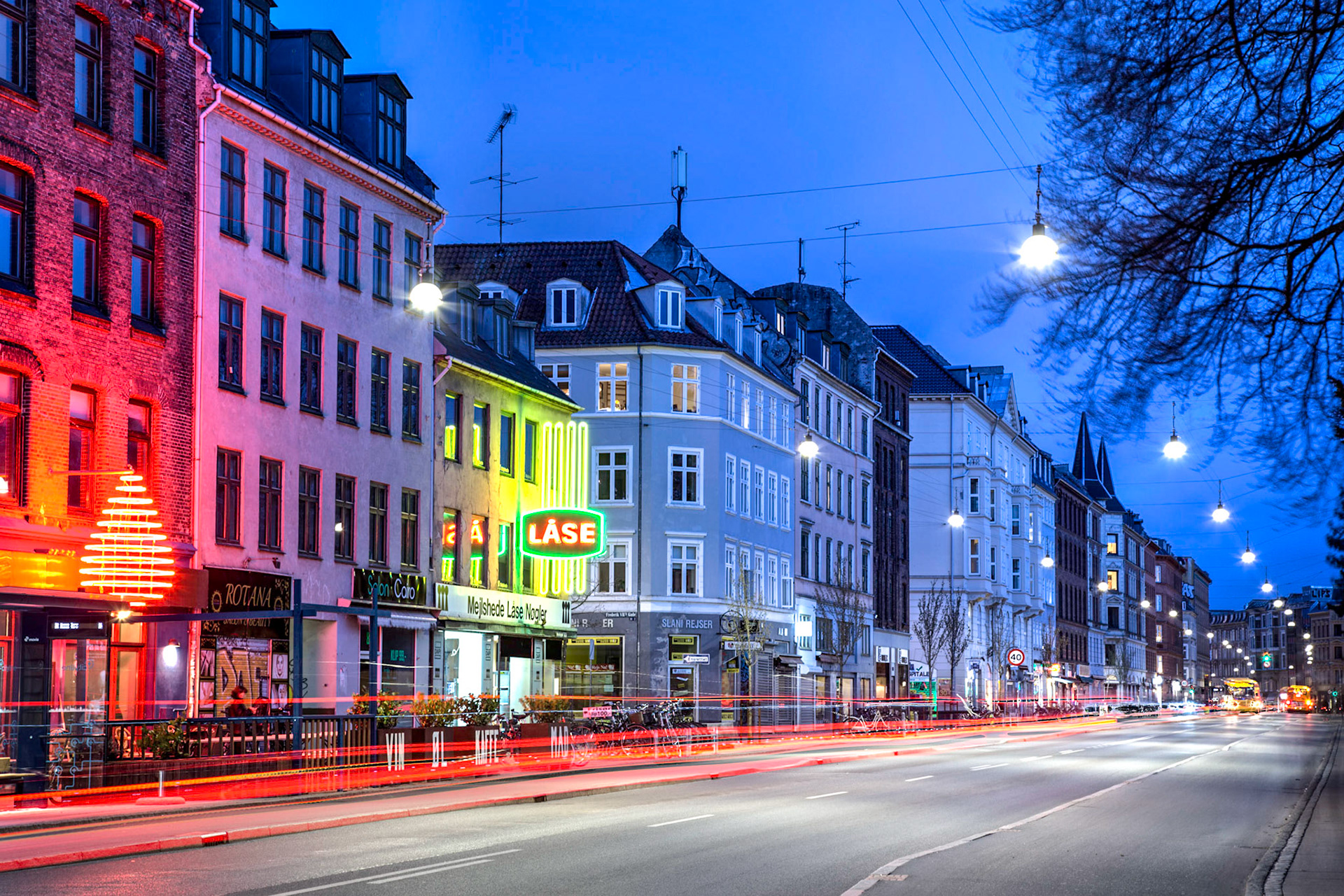 Copenhagen, Denmark - April 5, 2017: Long exposure photography of the illuminated street Norrebrogade in Norrebro district by night.