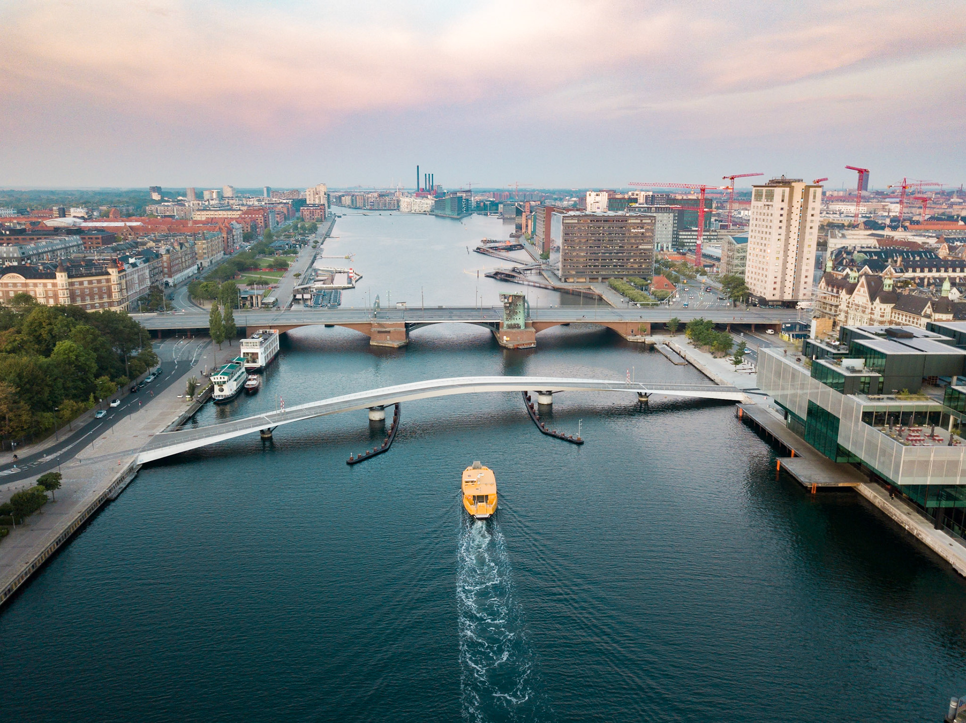 Copenhagen, Denmark - August 27, 2019: Aerial drone view of the old bridge Langebro and the modern pedestrian and cycling bridge Lille Langebro.