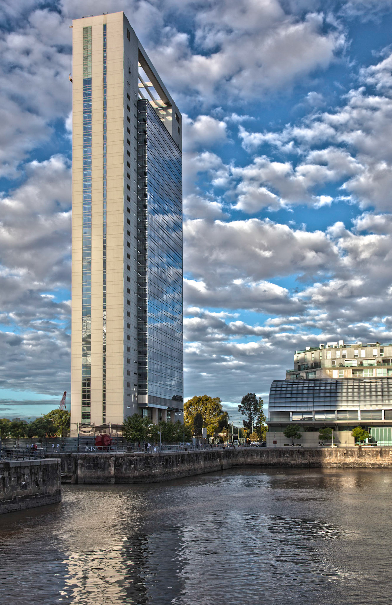 Architectural shot of contemporary building reflecting the clouds