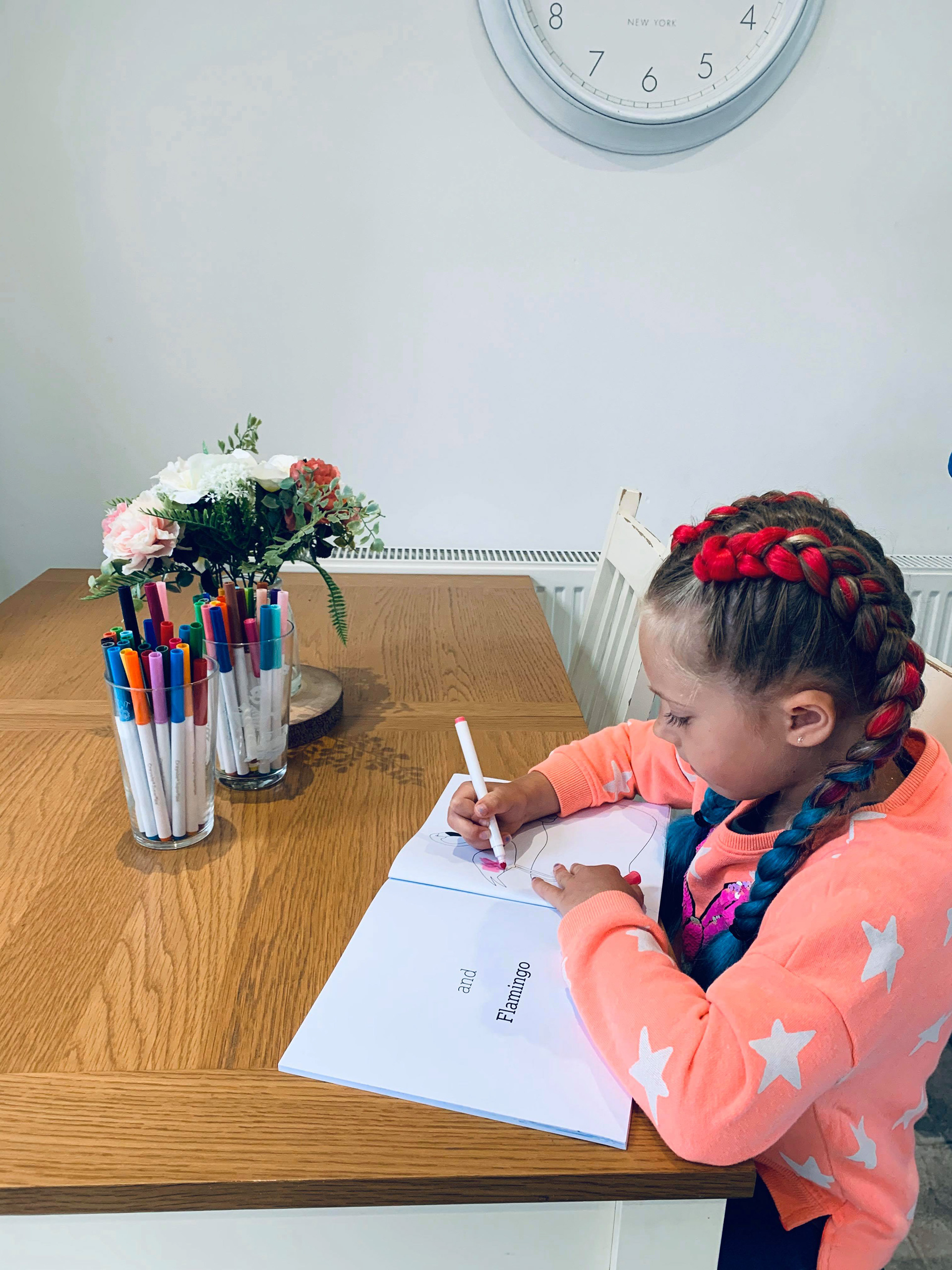 Daisy colouring in her book