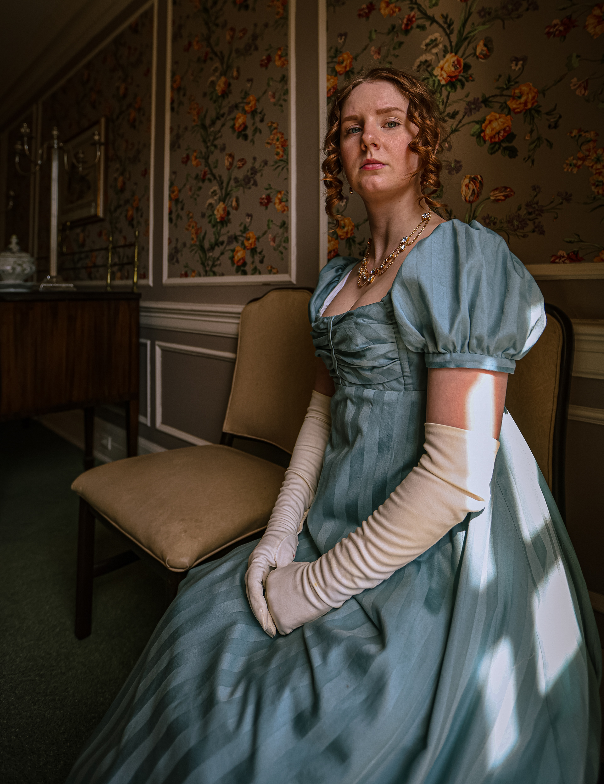 Alana Ellyn poses in her hand-made period gown at the Toledo Club, where the area’s first-ever Jane Austen Regency Ball will take place, on Thursday, March 17, 2022. For Toledo Blade.