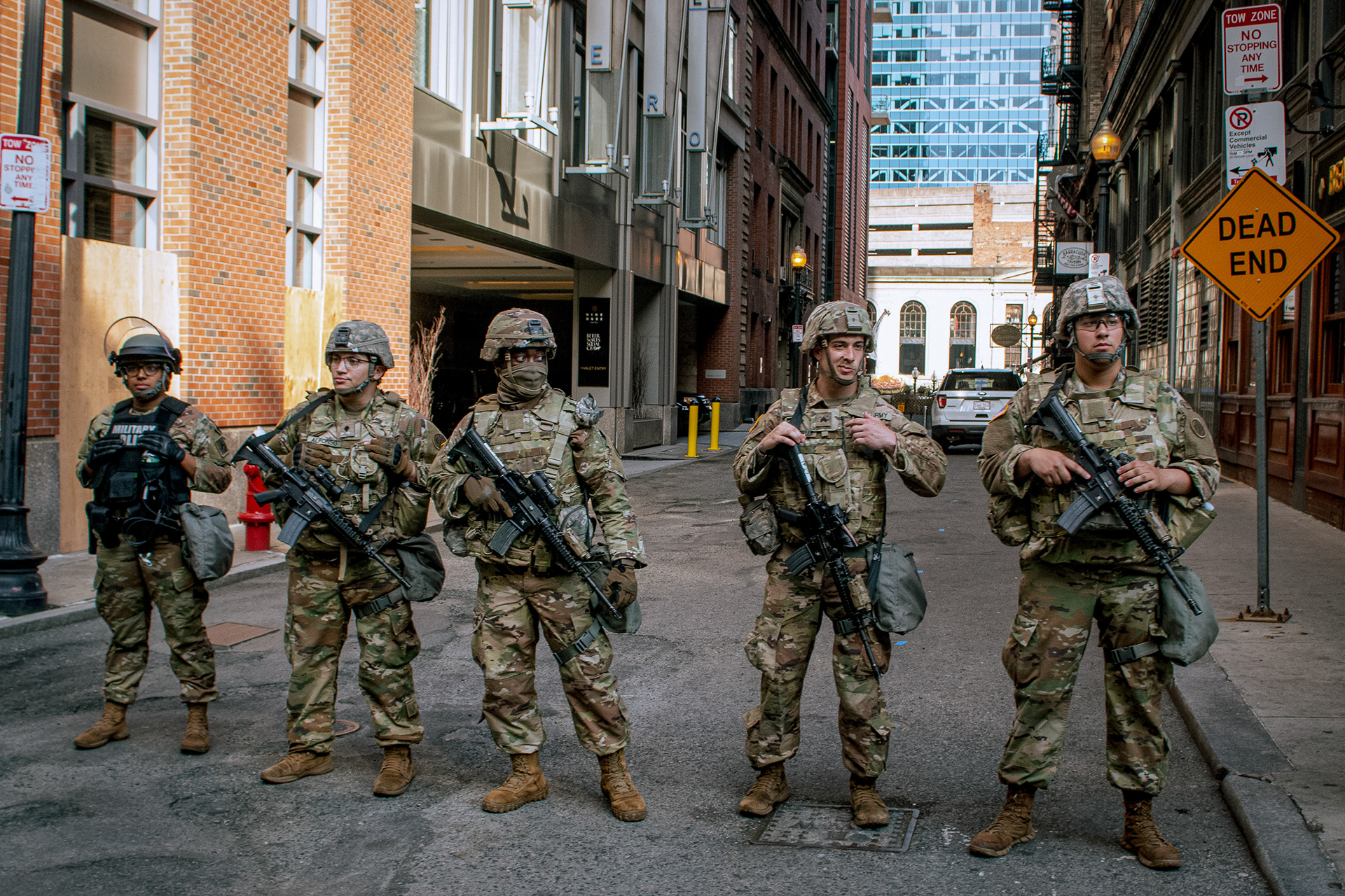 A line of military police officers stand at the end of a street in downtown Boston awaiting protestors on June 3, 2020.
