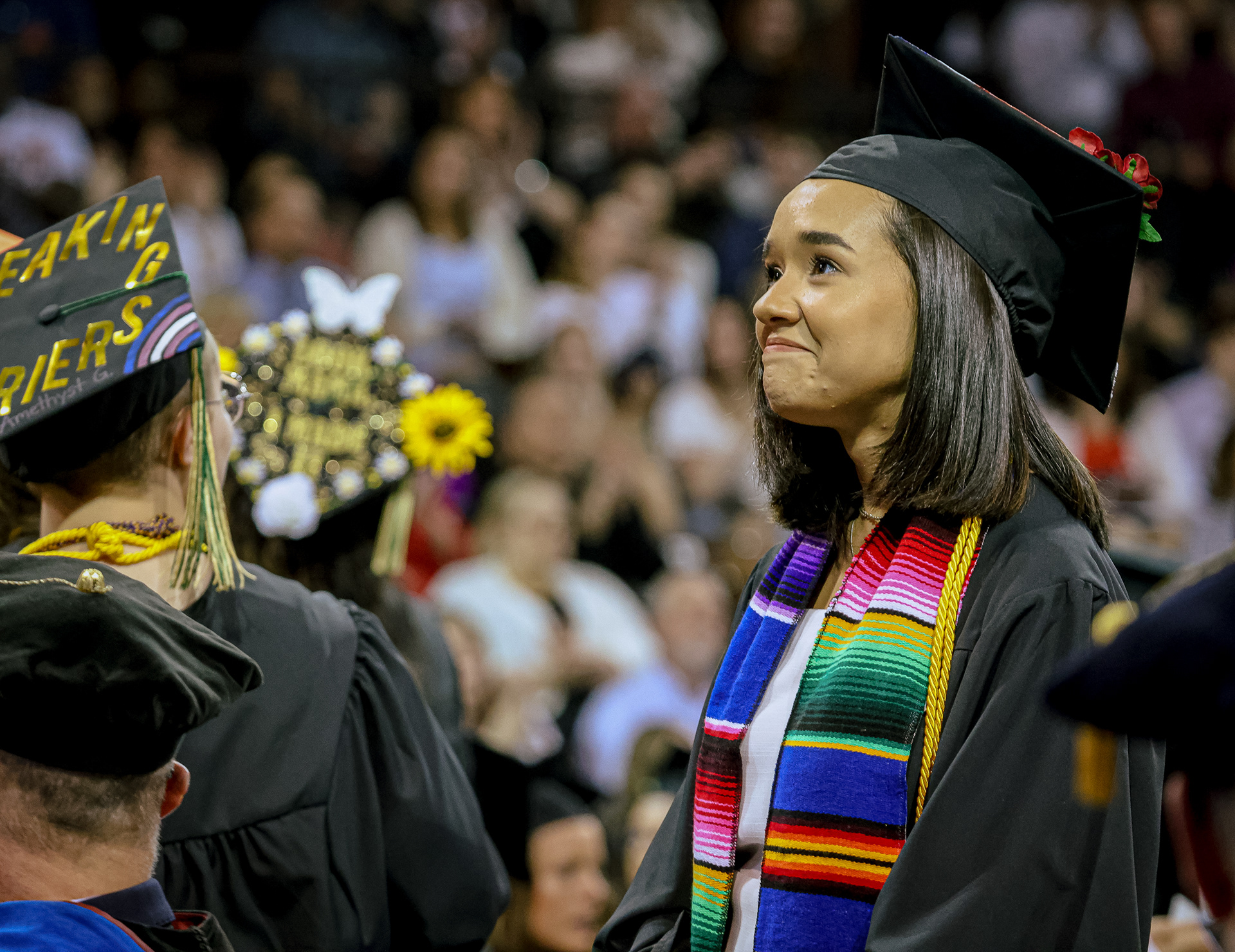 A student graduating with academic recognition smiles at her feat at the spring 2022 commencement ceremony at Bowling Green State University in Bowling Green, Ohio on Saturday, April 30, 2022. For Toledo Blade.