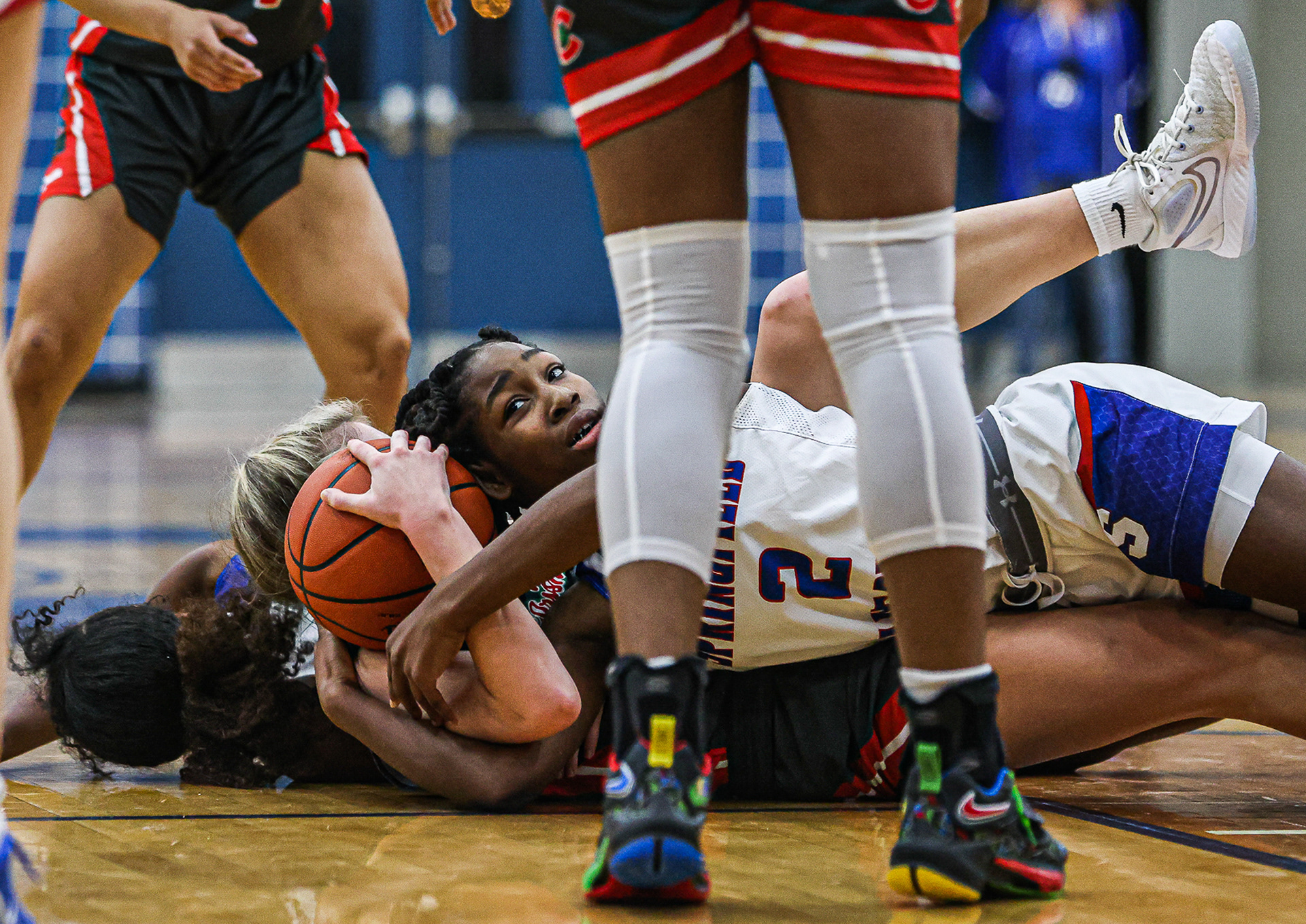 Springfield’s Kendall Carruthers (2) falls on top of Central Catholic’s Mary Ellis to grab a wild ball at Springfield High School in Holland, Ohio on Wednesday, December 28, 2022. For Toledo Blade.