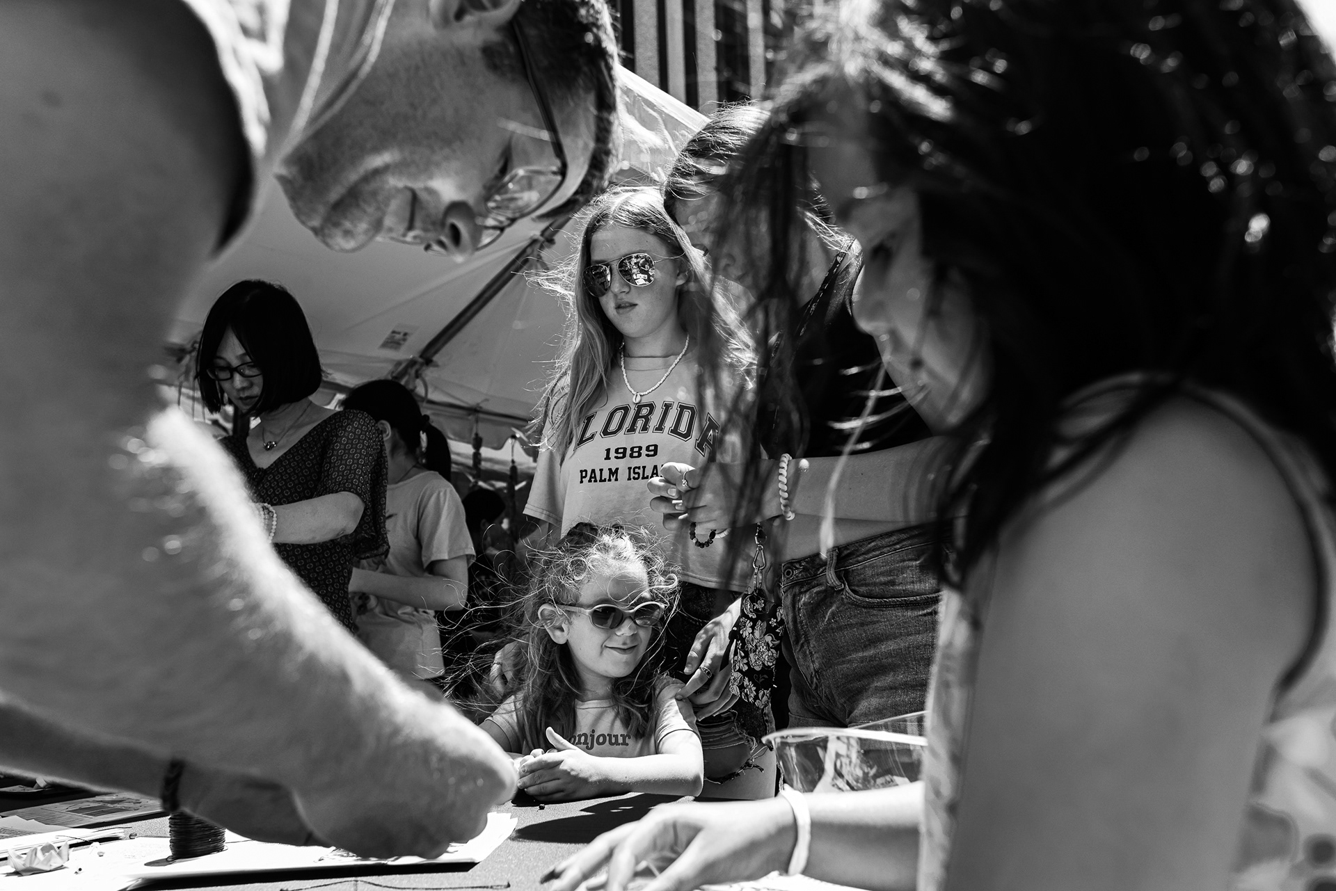 Families make beaded bracelets together at the University of Toledo kids section at the Toledo Sister Cities International Hosting Festival in Toledo on Saturday, June 25, 2022. For Toledo Blade.
