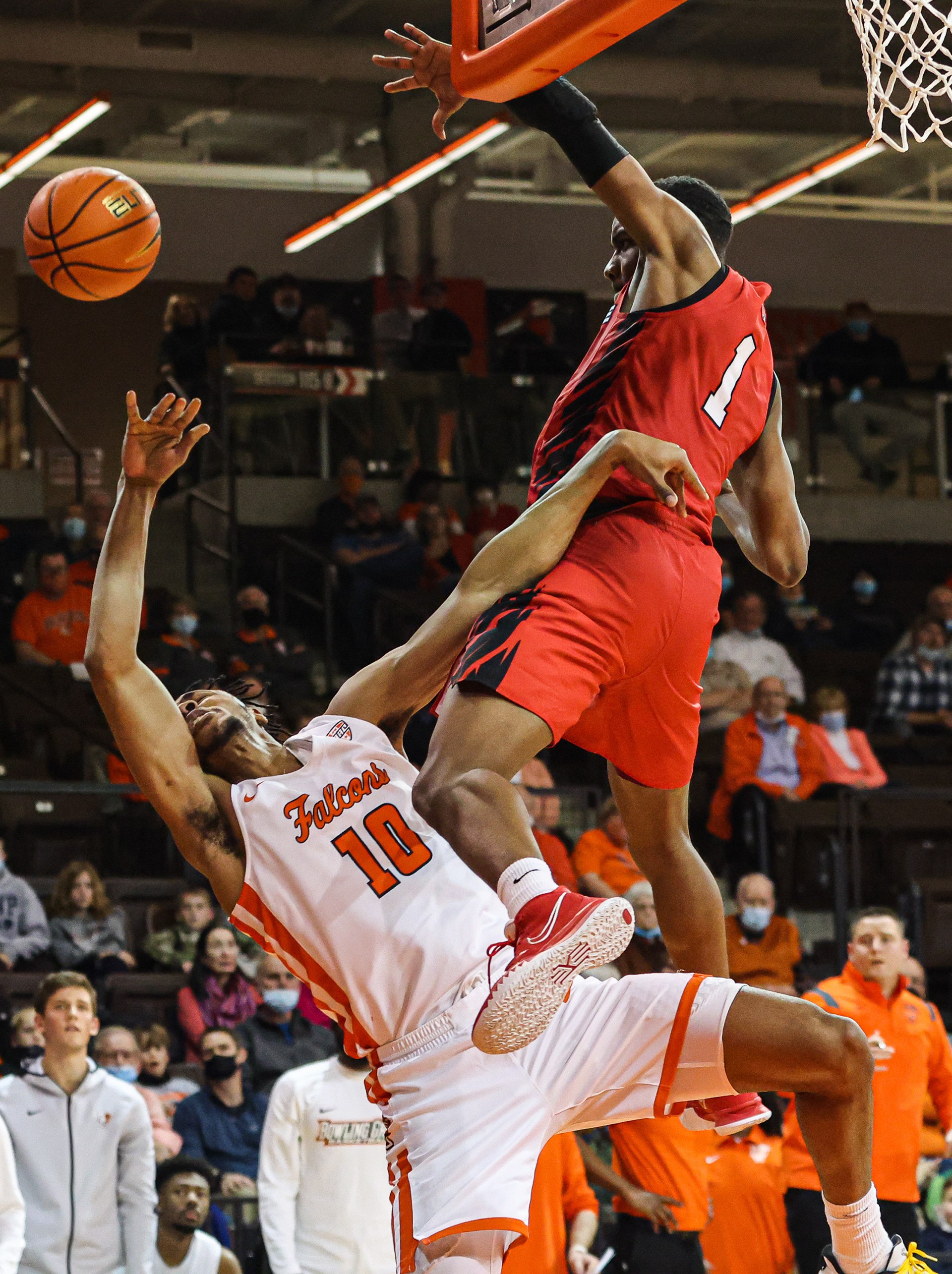 Bowling Green’s Cam Young (10) is slammed to the ground trying to shoot a layup by Ball State’s Demarius Jacobs (1) on Saturday, February 19, 2022. For Toledo Blade.
