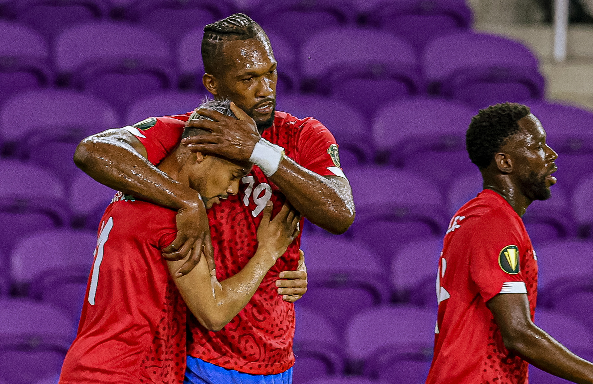 Costa Rica’s Kendall Waston (19) hugs teammate Ariel Lassiter (11) after scoring their second goal during match day one of three at the Concacaf Gold Cup at Exploria Stadium in Orlando Fla. on Monday, July 12, 2021. Costa Rica defeated Guadeloupe with a final score of 3-1. For Orlando Sentinel.