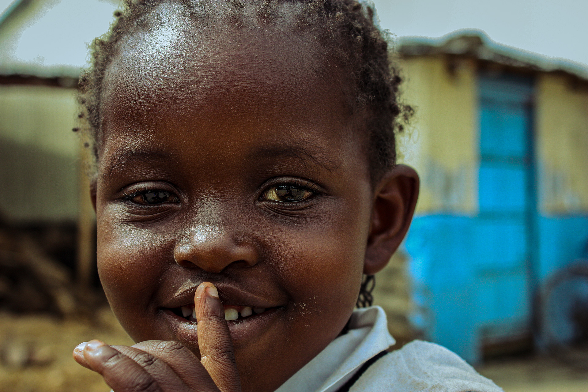 Mola, 5, smiles at the camera during break time from classes at The Walk Centre primary school in Nakuru, Kenya on July 12, 2016. 