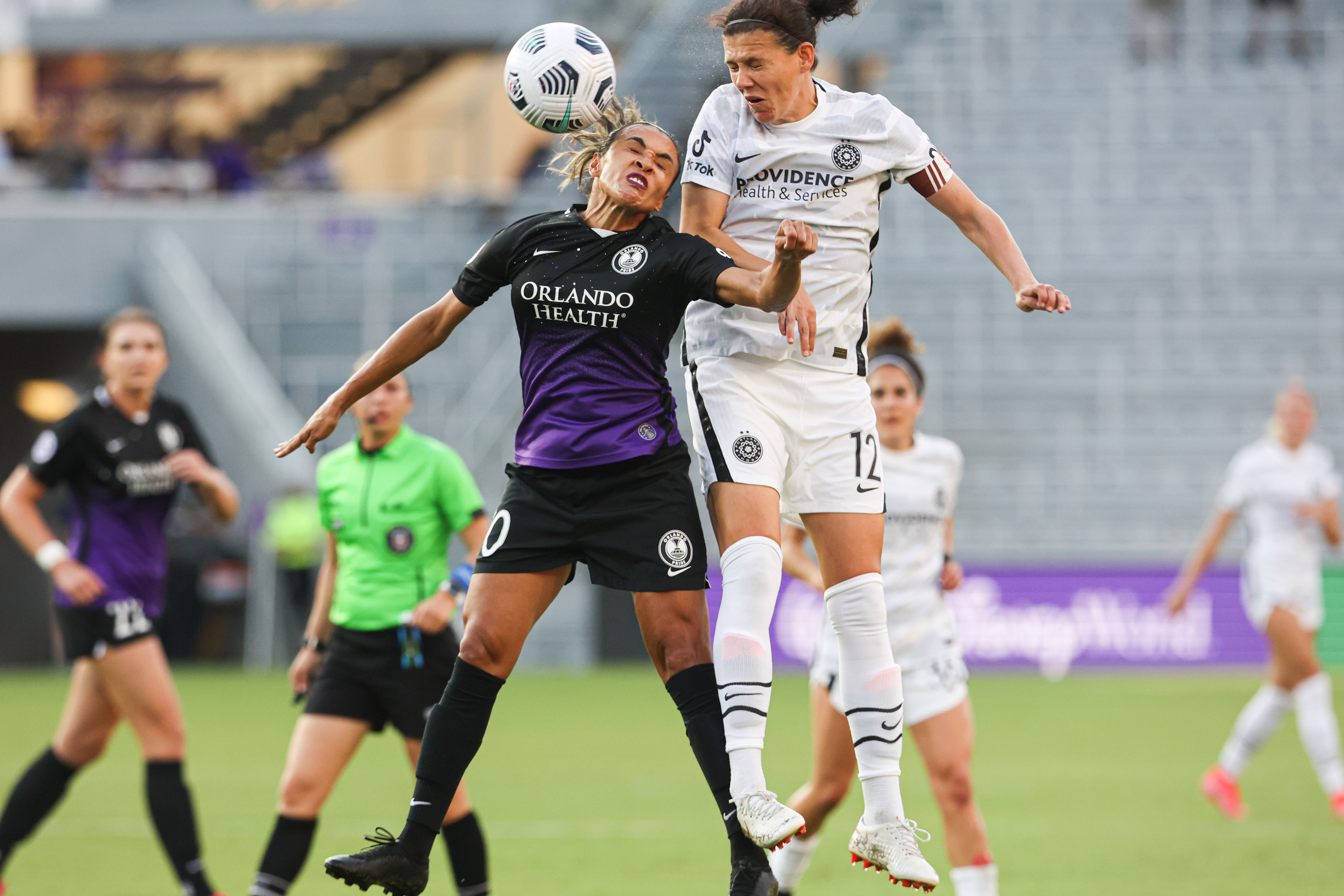 Orlando Pride's Marta winces as she does a header.