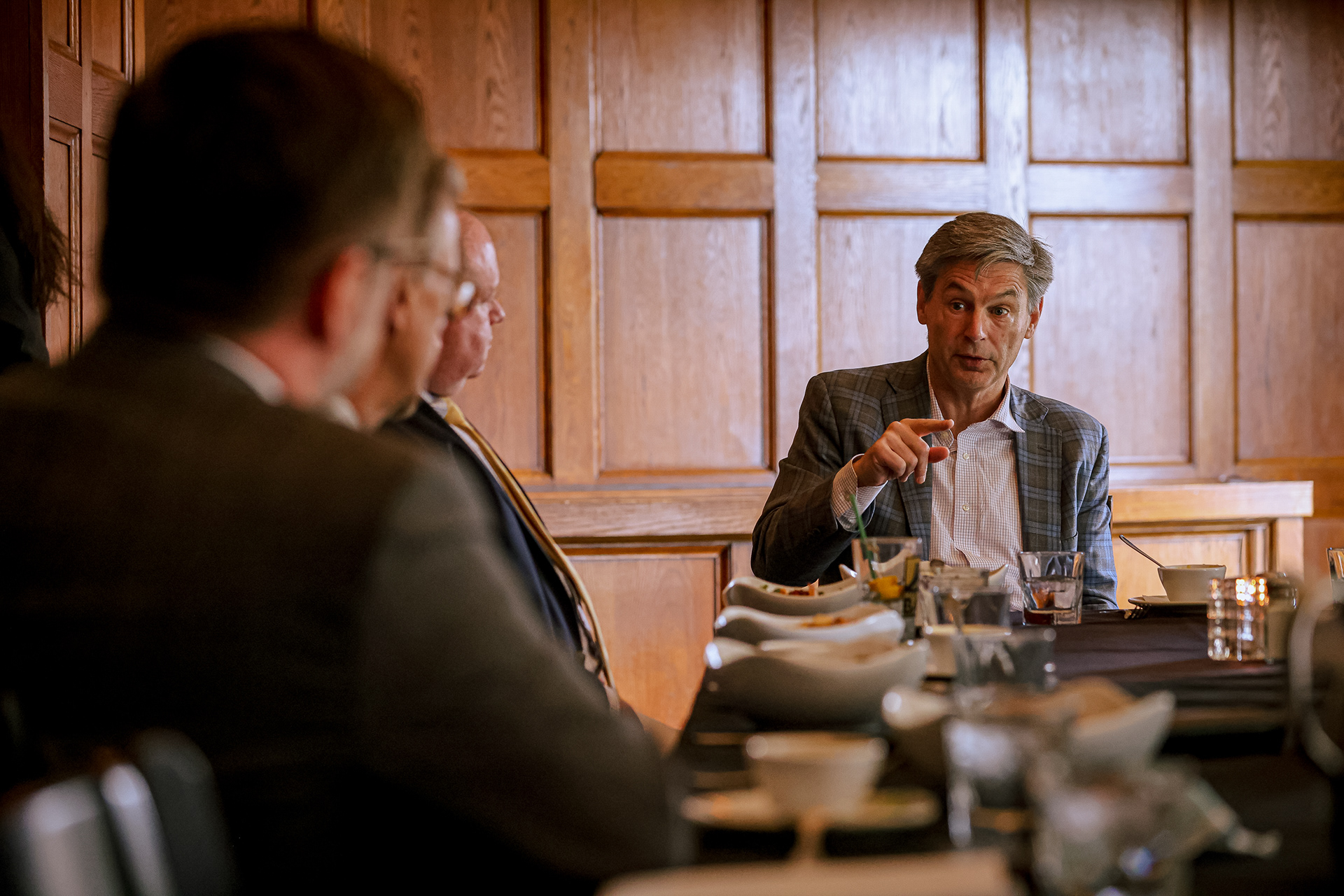 Ohio state Sen. Matt Dolan, right, speaks at a roundtable with Ohio Business representatives to discuss his campaign for U.S. Senate at Oliver House in Toledo, Ohio on Wednesday, April 27, 2022. For Toledo Blade.