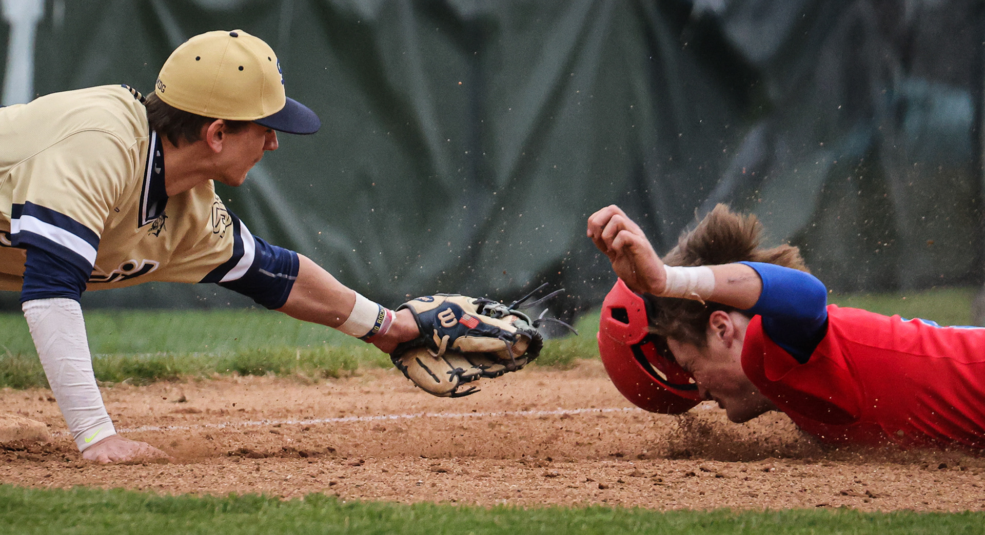 St. John’s Jesuit’s Trey Lake, left, taps out St. Francis de Sales’s Josiah Erd slides into third base at Don Kober Field in Toledo, Ohio on Wednesday, April 20, 2022. For Toledo Blade.