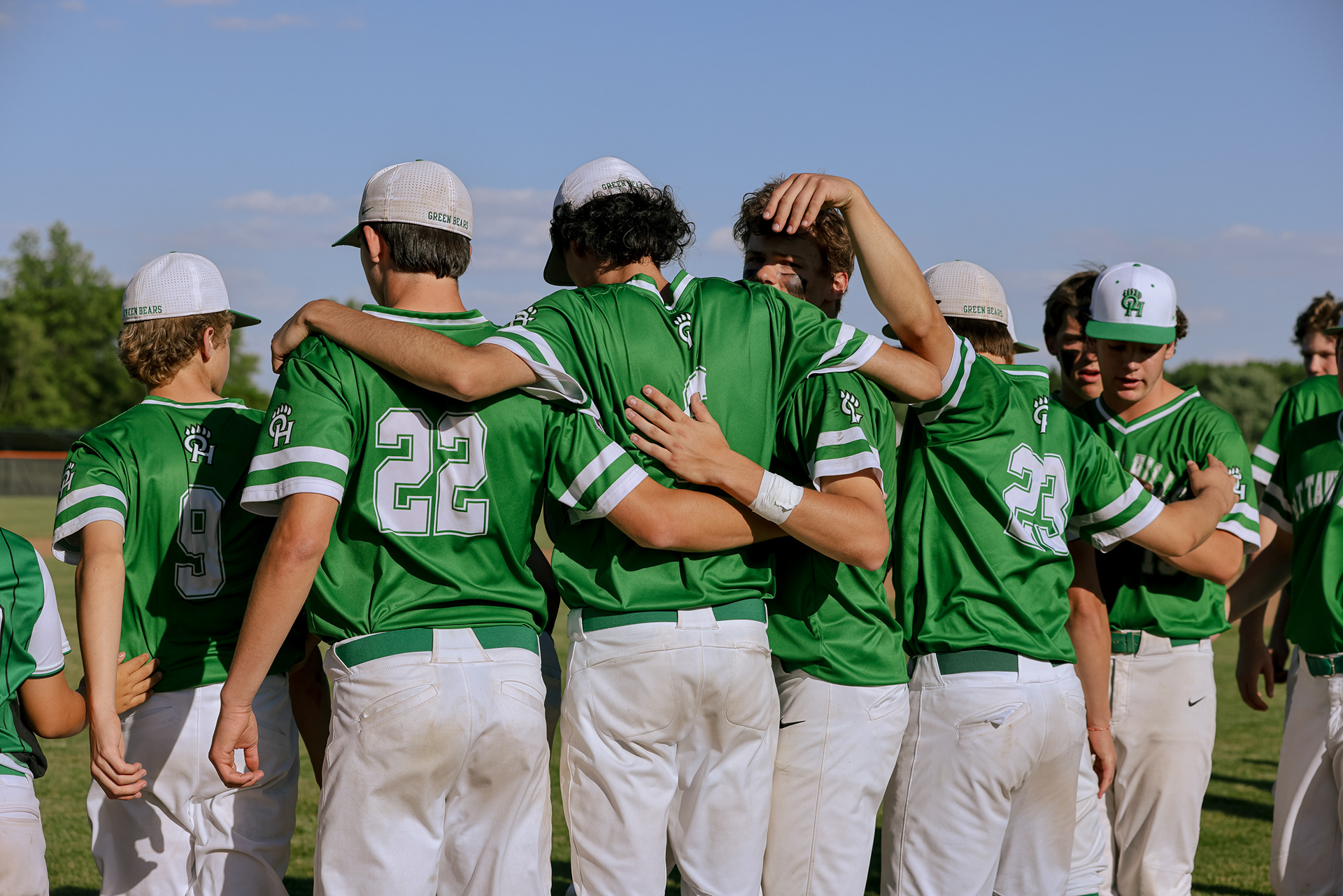Ottawa Hills Green Bears players wrap arms around each other after losing 3-1 against the Milan Edison Chargers at the Division III regional baseball finals in Elida, Ohio on Friday, June 3, 2022. For Toledo Blade.