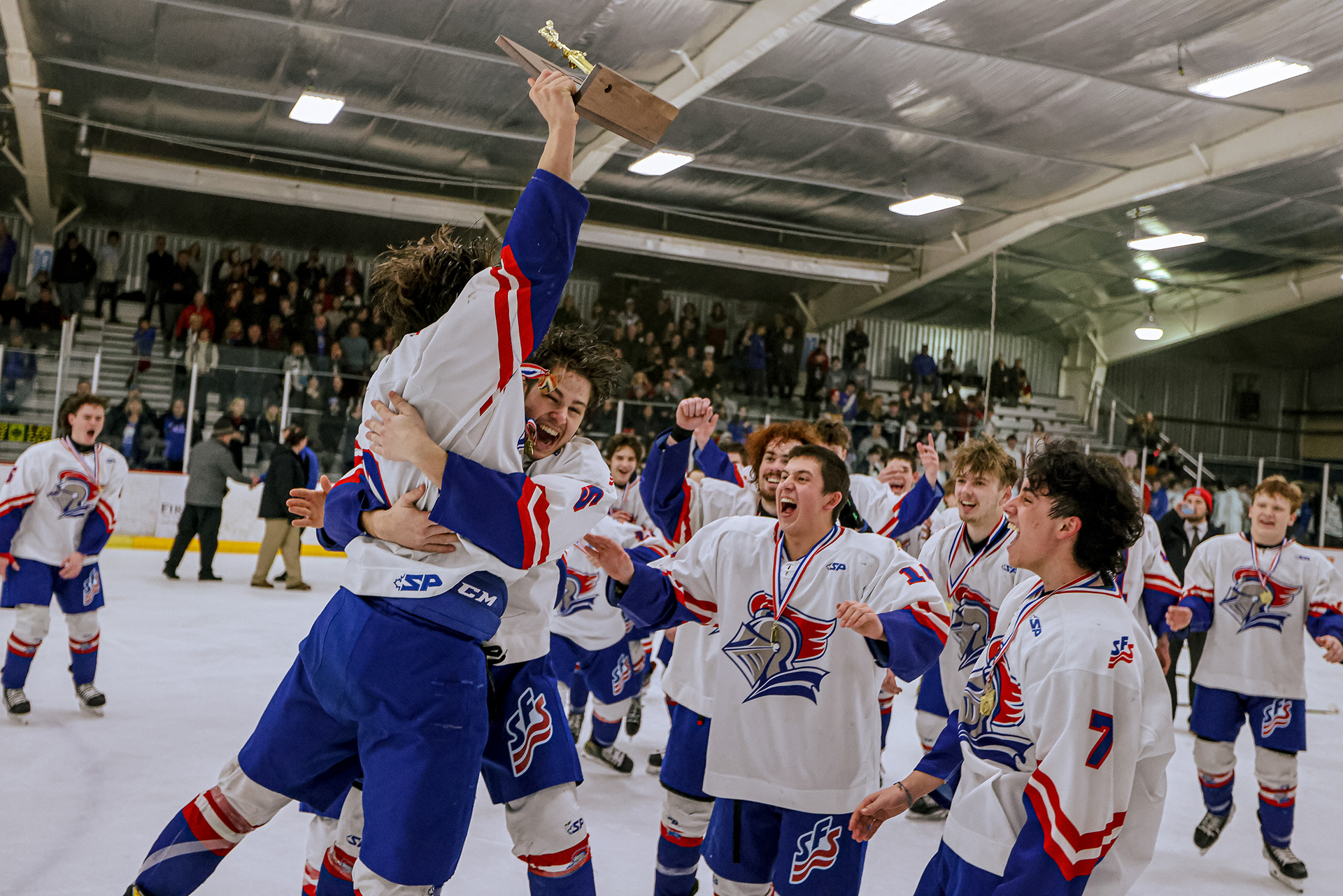 St. Francis players scream in celebration as captain Gordon Hunt, left, holds up their trophy at the regional hockey final at Tam-O-Shanter in Sylvania on Friday, March 4, 2022. For Toledo Blade.