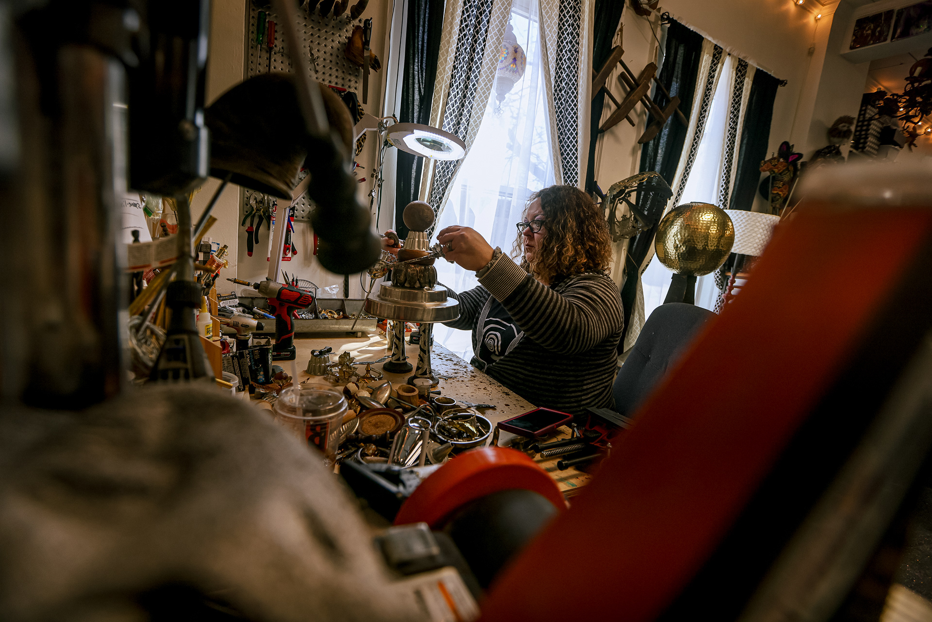 Shannon Eis fits wings on a sculpture at Wonderland Studios in Toledo on Monday, March 14, 2022. For Toledo Blade.