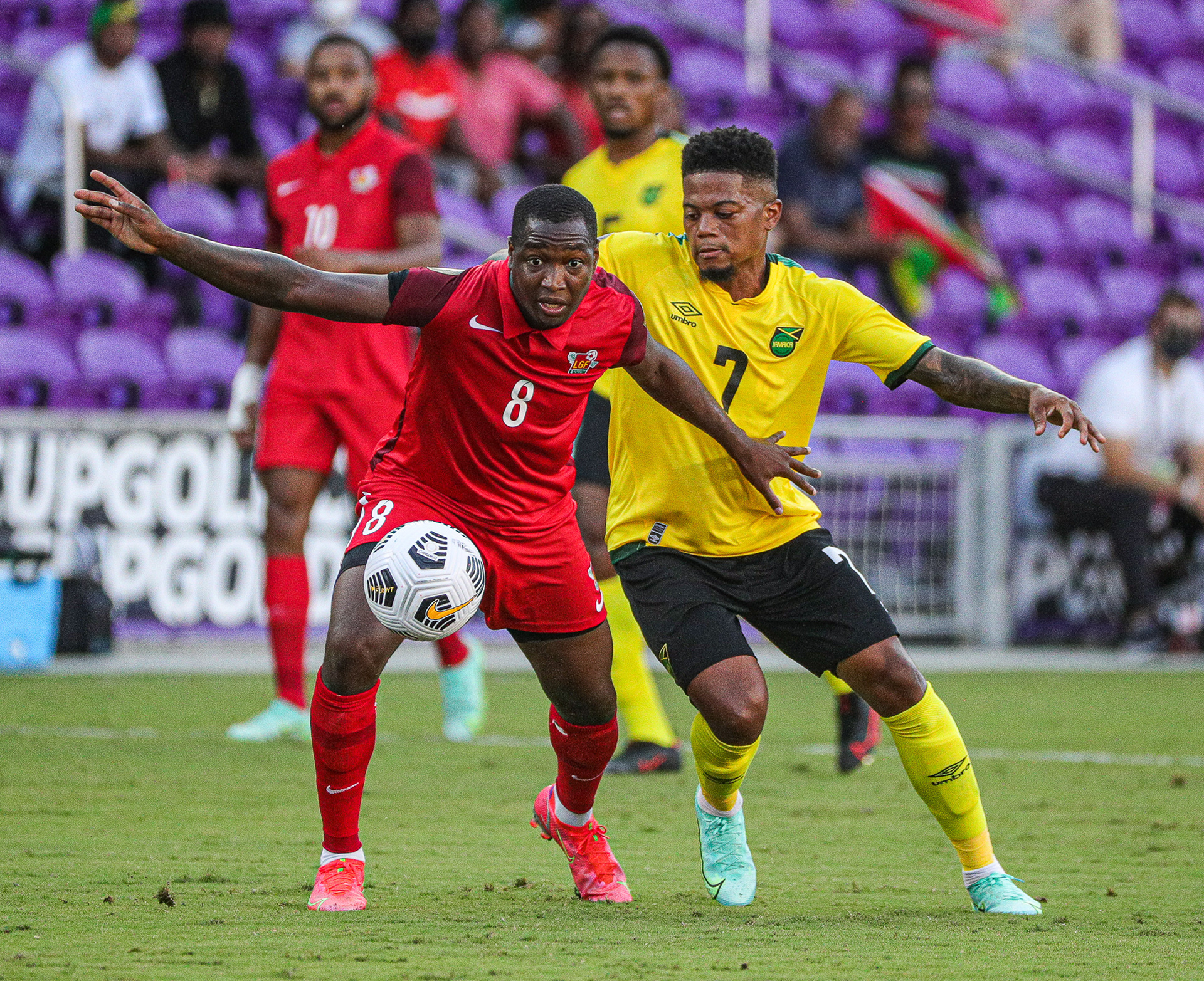 Defensive Midfield Kévin Malpon (8) from Guadeloupe tries to fight off Jamaica’s Right Winger Leon Bailey (7) for possession of the ball during their second match at the Concacaf Gold Cup. Guadeloupe played Jamaica at Exploria Stadium in Orlando, Fla., on Friday, July 16, 2021 for match day two of three of the Concacaf Gold Cup.  For Orlando Sentinel.