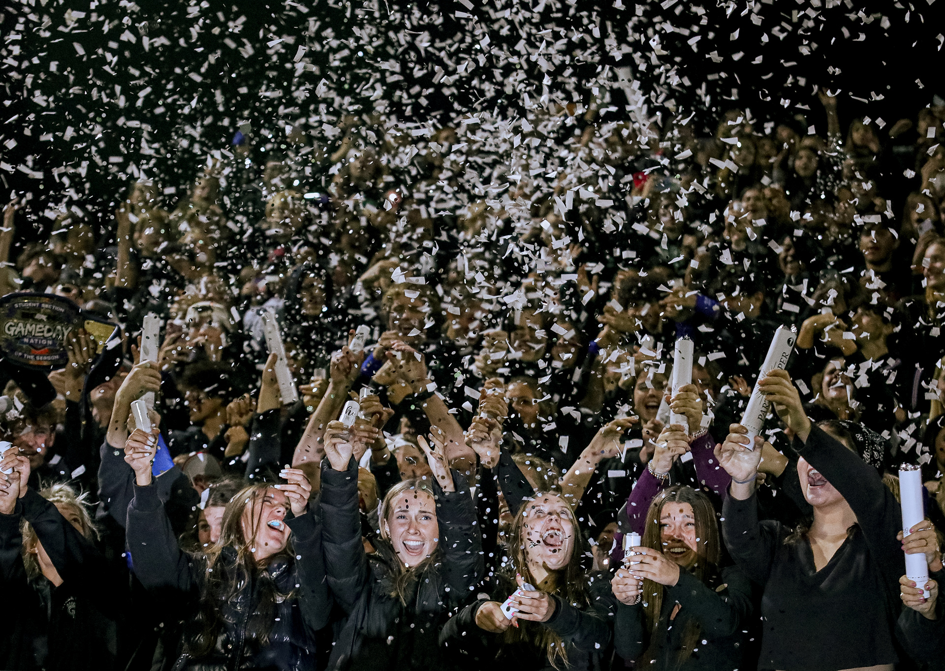 Ottawa Hills High School students set off confetti poppers in the student section at Niedermeier Stadium in Ottawa Hills, Ohio on Friday, October 21, 2022. For Toledo Blade.