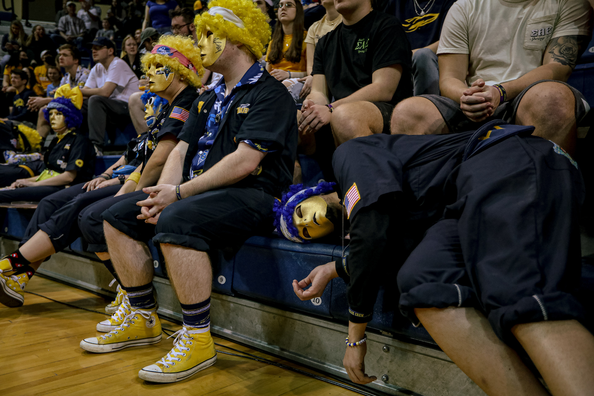A member of the Blue Crew pretends to sleep as University of Dayton players are announced at Savage Arena in Toledo on Wednesday, March 16, 2022. For Toledo Blade.