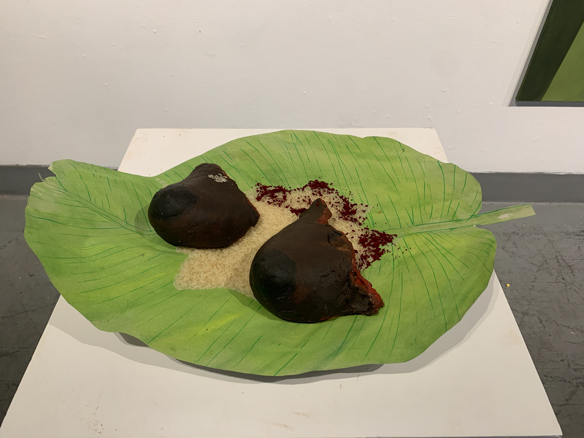 The Price of Dignity, 2025, Clay, banana leaf, rice, and natural pigments