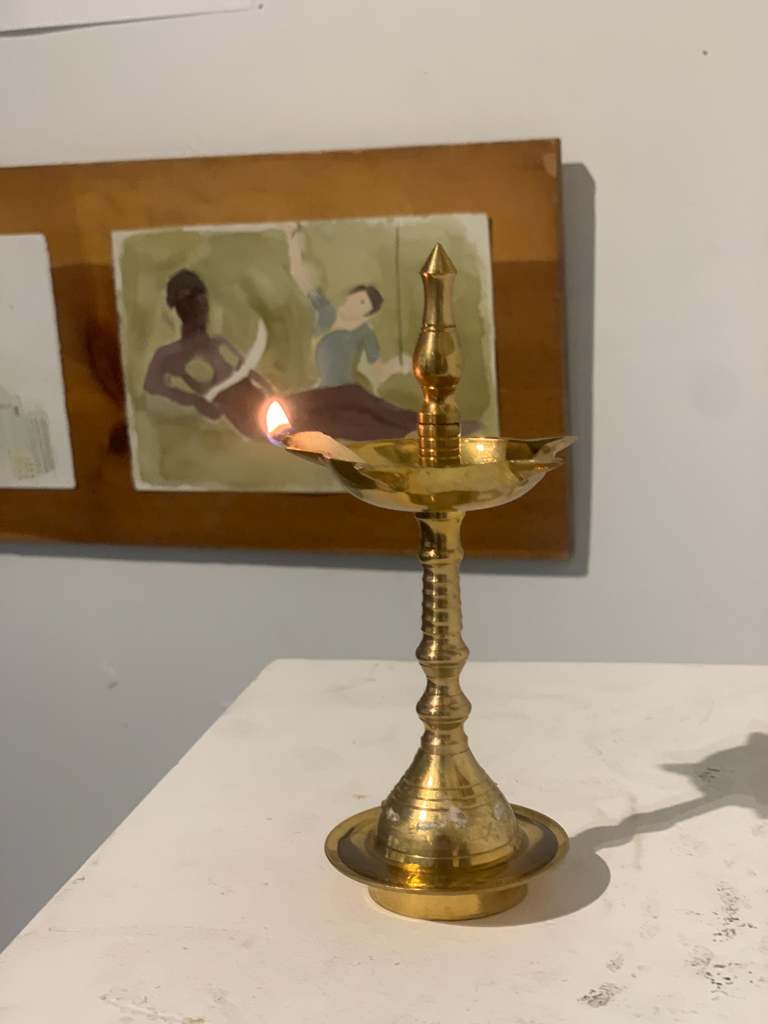 Lamp (Diya) Honoring Nangeli (Brass lamp, cotton wick, and flame)